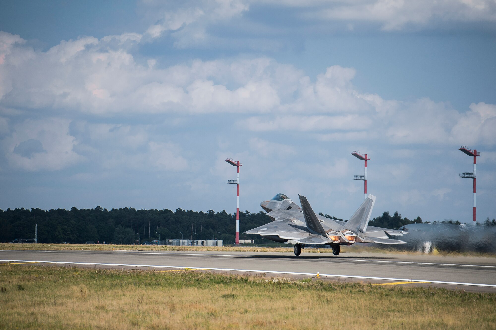 A U.S. Air Force F-22 Raptor fighter pilot assigned to the 95th Fighter Squadron at Tyndall Air Force Base, Fla., takes off from the runway Sept. 11, 2015, at Spangdahlem Air Base, Germany. The U.S. Air Force deployed four F-22 Raptors, one C-17 Globemaster III, and approximately 60 Airmen and associated equipment to Spangdahlem to train with NATO allies and partners. These relationships are critical to ensuring safety, and stability in the European region. The forward presence allows the rotation of units from the U.S. to augment the forces in Europe whenever needed. (U.S. Air Force photo by Staff Sgt. Christopher Ruano/Released)