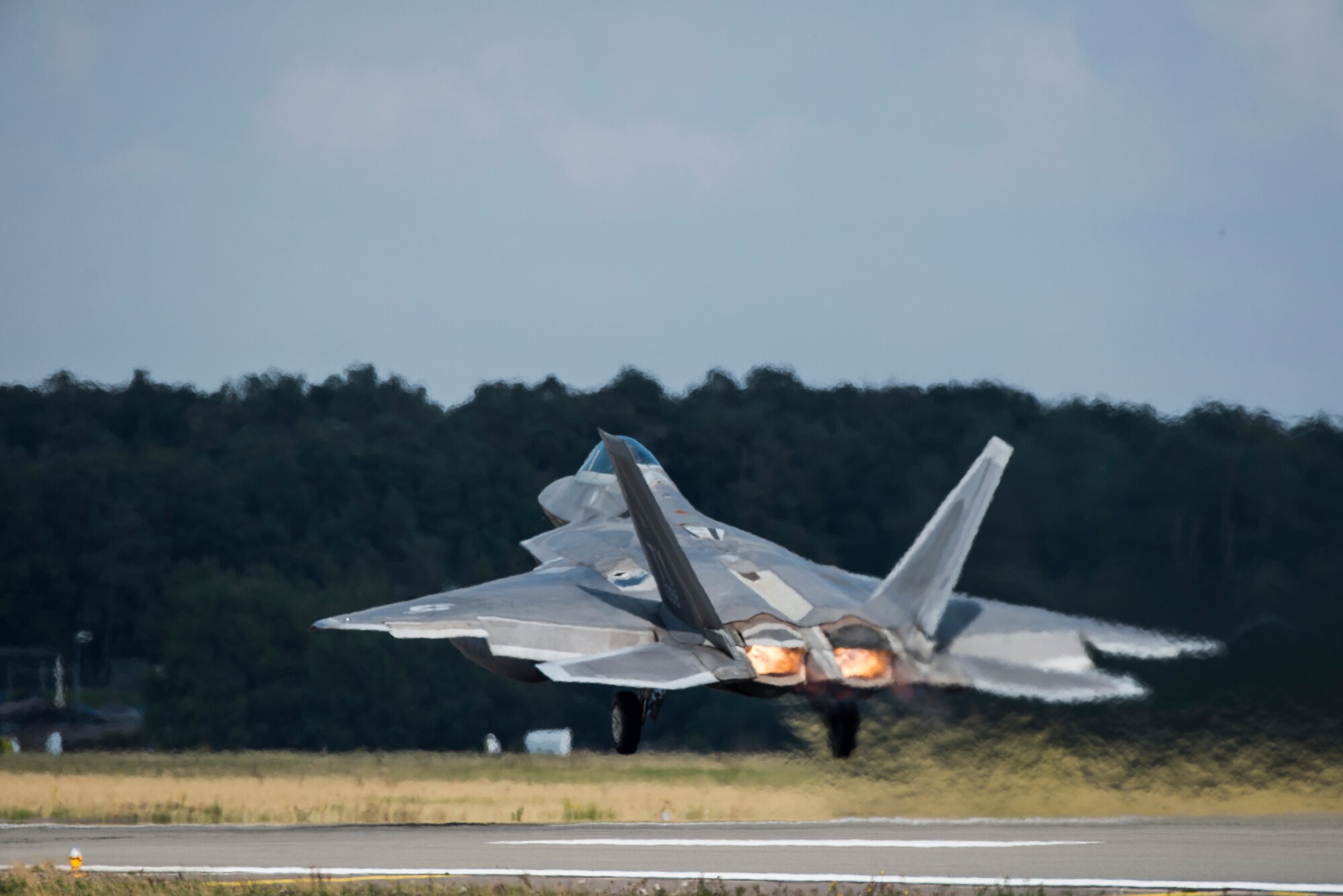 A U.S. Air Force F-22 Raptor fighter pilot assigned to the 95th Fighter Squadron at Tyndall Air Force Base, Fla., soars in the sky after take off Sept. 11, 2015, at Spangdahlem Air Base, Germany. The aircraft conducted air training with other Europe-based aircraft and forward deployed from Spangdahlem Air Base, Germany, to maximize training opportunities while demonstrating the U.S. commitment to NATO allies and the security of Europe. (U.S. Air Force photo by Staff Sgt. Christopher Ruano/Released)