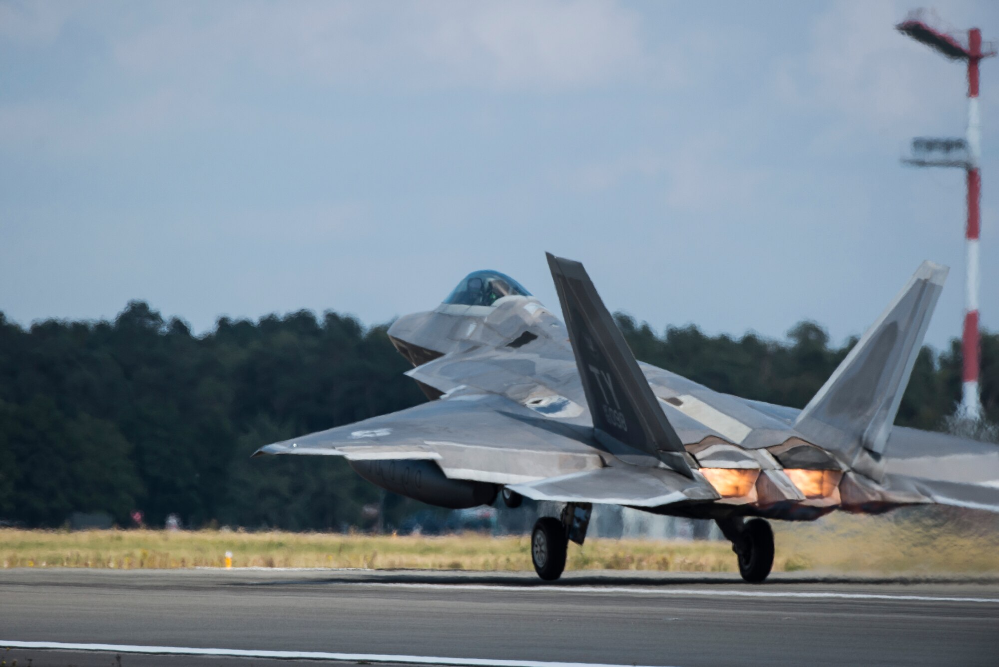 A U.S. Air Force F-22 Raptor fighter pilot assigned to the 95th Fighter Squadron at Tyndall Air Force Base, Fla., takes off from the runway Sept. 11, 2015, at Spangdahlem Air Base, Germany. The F-22s deployed from the 95th Fighter Squadron at Tyndall Air Force Base, Fla., as part of the European Reassurance Initiative and conducted air training with other Europe-based aircraft while demonstrating U.S. commitment to NATO allies and the security of Europe. (U.S. Air Force photo by Staff Sgt. Christopher Ruano/Released)