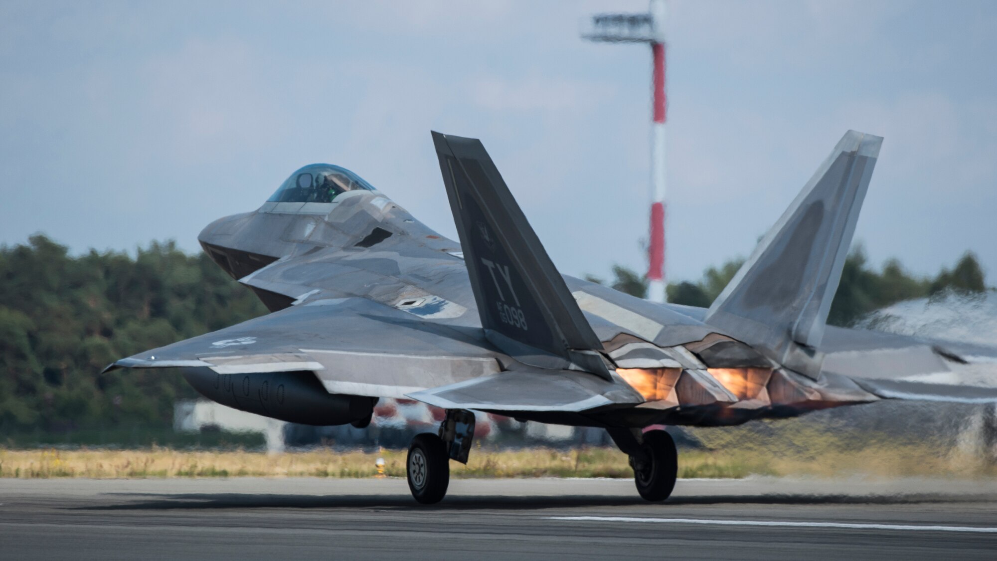A U.S. Air Force F-22 Raptor fighter pilot assigned to the 95th Fighter Squadron at Tyndall Air Force Base, Fla., takes off from the runway Sept. 11, 2015, at Spangdahlem Air Base, Germany. The U.S. Air Force deployed four F-22 Raptors, one C-17 Globemaster III, and approximately 60 Airmen and associated equipment to Spangdahlem to train with NATO allies and partners. These relationships are critical to ensuring safety and stability in the European region. The forward presence allows the rotation of units from the U.S. to augment the forces in Europe whenever needed. (U.S. Air Force photo by Staff Sgt. Christopher Ruano/Released)