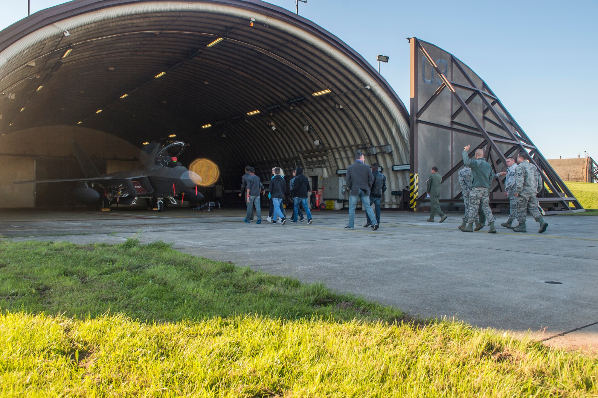 Junior ROTC members from Bitburg Middle-High School visit an F-22 Raptor fighter aircraft during a tour of an F-22 in a hardened aircraft shelter at Spangdahlem Air Base, Germany, Sept. 10, 2015. Two F-22 pilots, assigned to the 95th Fighter Squadron at Tyndall Air Force Base, Fla., lead the tour and informed the students of the aircraft’s capabilities and mission. (U.S. Air Force photo by Airman 1st Class Luke Kitterman/Released)
