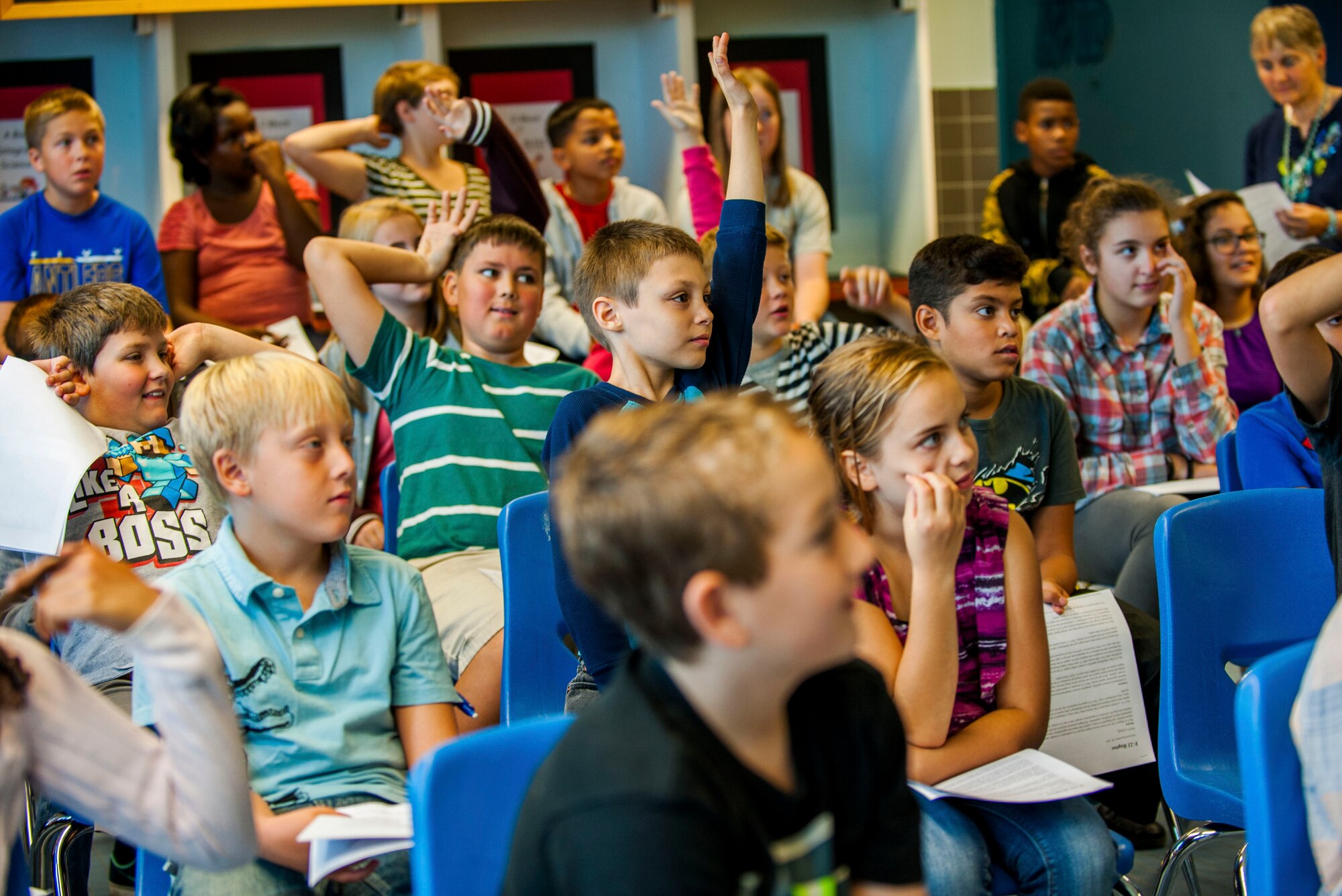 Spangdahlem Middle School students ask questions during a visit on Spangdahlem Air Base, Germany, Sept. 9, 2015. The middle school invited the pilots to speak as part of a program that exposes students to different career fields involved with advanced sciences and technology. The 95th FS, from Tyndall Air Base, Fla., sent the F-22 Raptors to Spangdahlem on their first training mission to Europe as part of the European Reassurance Initiative, which provides support to NATO allies and partners in Europe. (U.S. Air Force photo by Airman 1st Class Timothy Kim/Released)