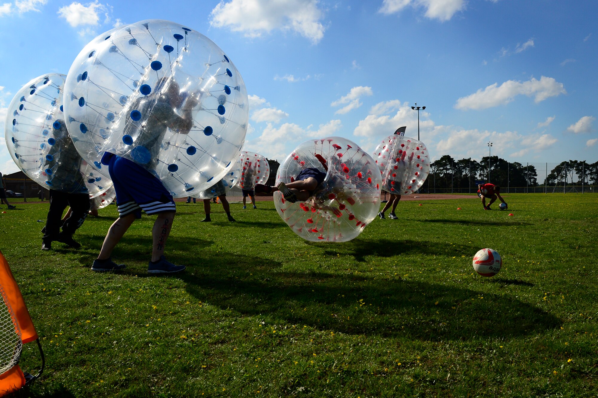 Teams Lakenheath and Mildenhall battle it out on the field during a game of Zorb soccer during the second annual Battle of the Badges at Royal Air Force Lakenheath, England, Sept. 10, 2015. The competition between the first responders of RAFs Lakenheath and Mildenhall is intended as an opportunity for them to remember and commemorate how first responders came together during the 9/11 attacks. (U.S. Air Force photo by Airman 1st Class Erin R. Babis/Released)