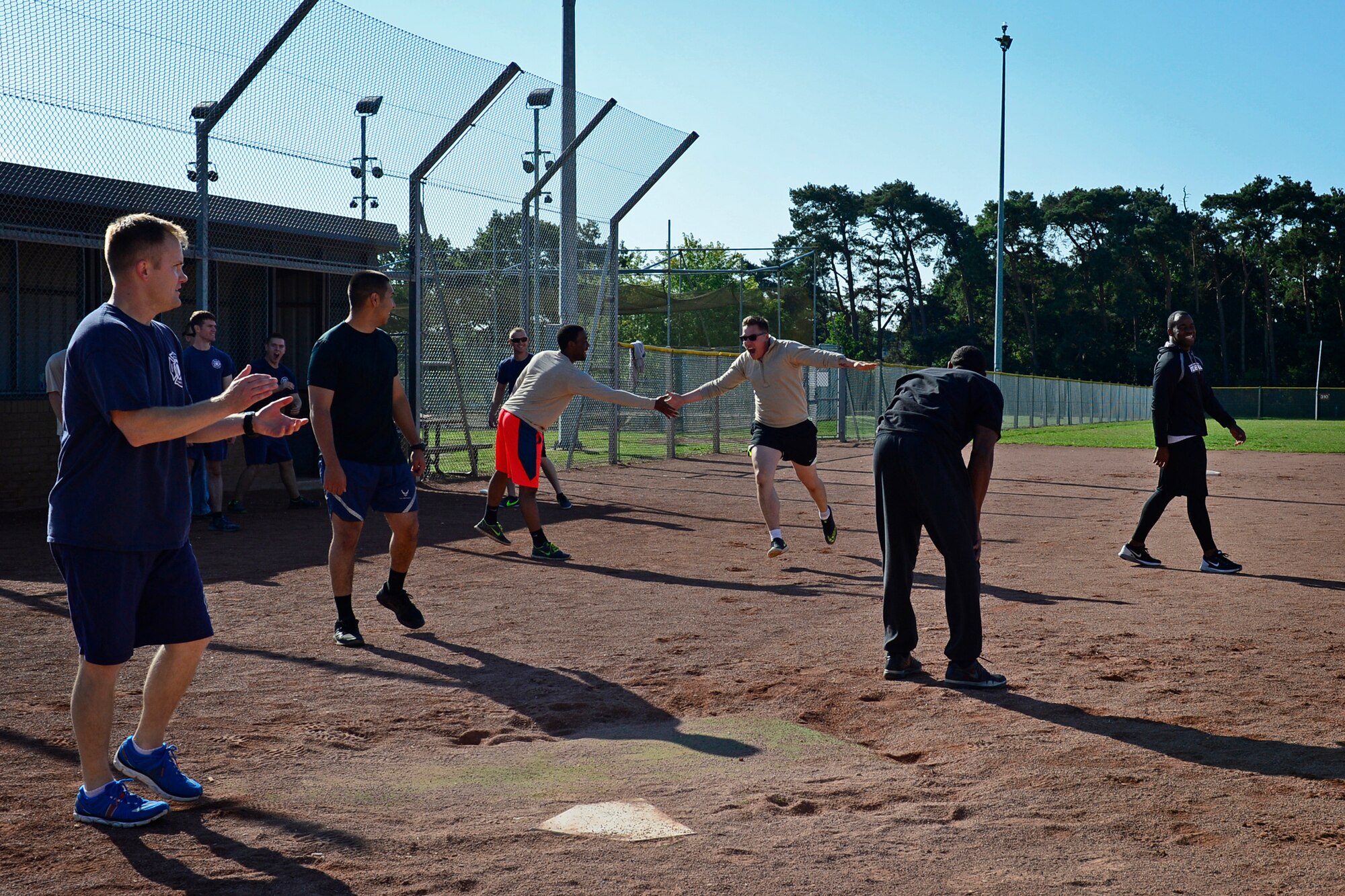 Team Mildenhall celebrates as they score during a kickball match for the second annual Battle of the Badges at Royal Air Force Lakenheath, England, Sept. 10, 2015. The competition, comprised of four events, was designed to test the strength, endurance and agility of the first responders. (U.S. Air Force photo by Airman 1st Class Erin R. Babis/Released)
