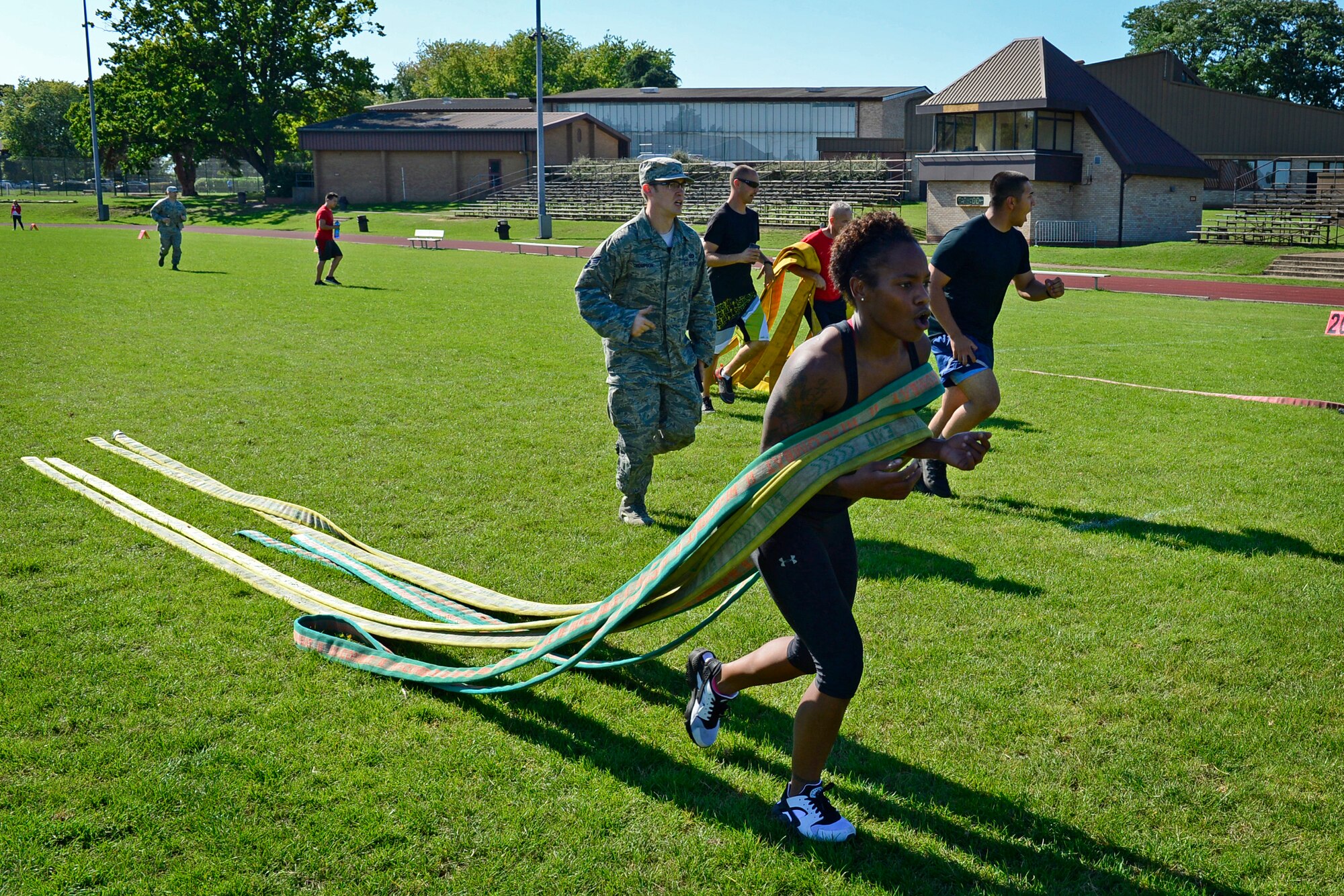 Team Mildenhall finishes the last leg of a relay event during the second annual Battle of the Badges at Royal Air Force Lakenheath, England, Sept. 10, 2015. The competition, comprised of four events, was designed to test the strength, endurance and agility of the first responders. (U.S. Air Force photo by Airman 1st Class Erin R. Babis/Released)