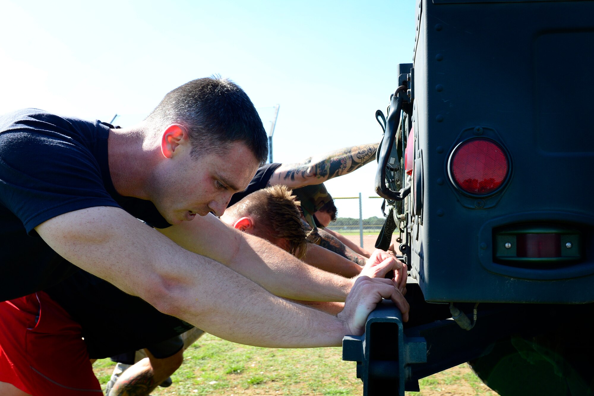 Team Lakenheath pushes a Humvee across a field during a relay event at the second annual Battle of the Badges at Royal Air Force Lakenheath, England, Sept. 10, 2015. The competition, comprised of four events, was designed to test the strength, endurance and agility of the first responders. (U.S. Air Force photo by Airman 1st Class Erin R. Babis/Released)