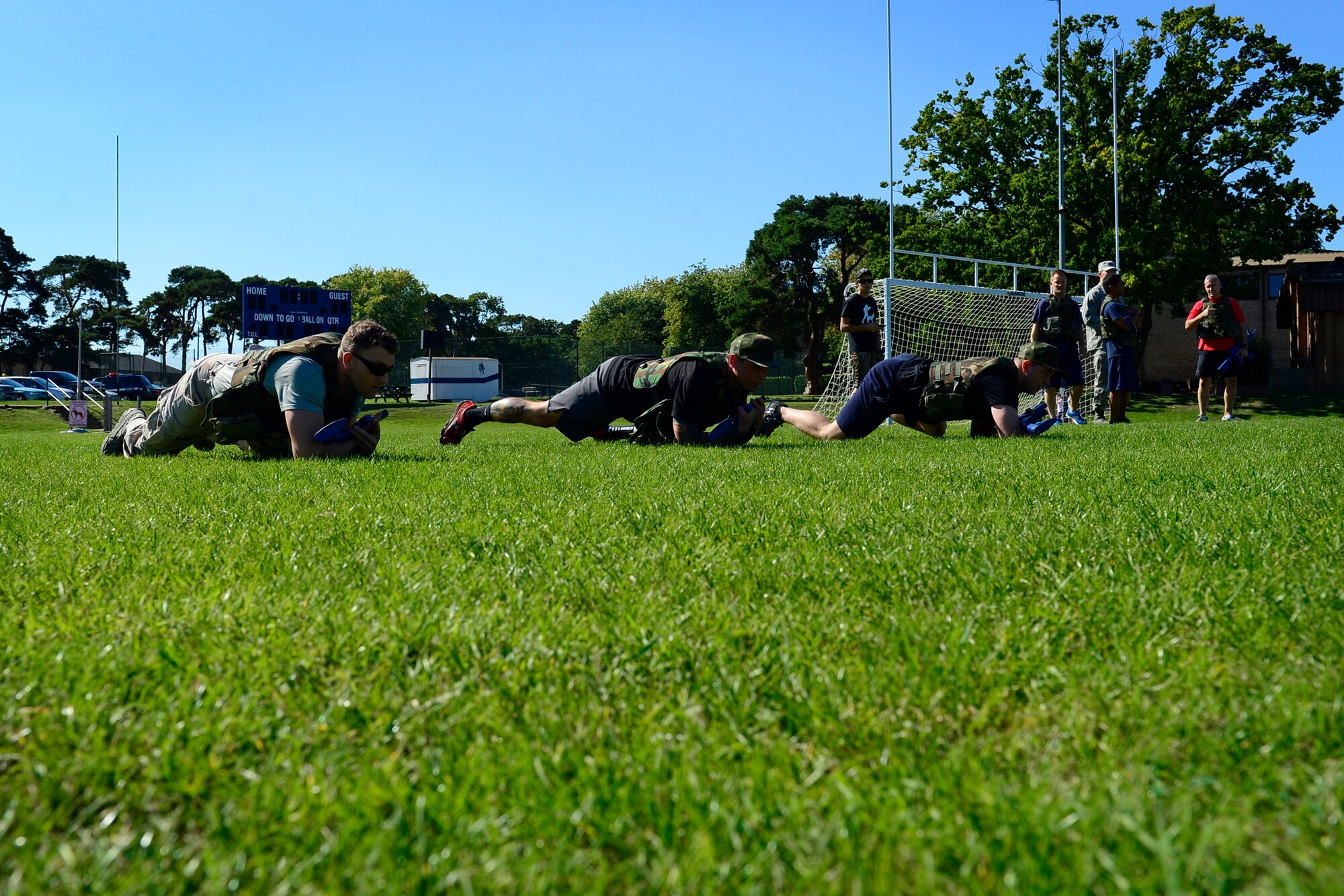 Team Lakenheath’s firefighters perform a high crawl during a relay event at the second annual Battle of the Badges at Royal Air Force Lakenheath, England, Sept. 10, 2015. The competition, comprised of four events, was designed to test the strength, endurance and agility of the first responders. (U.S. Air Force photo by Airman 1st Class Erin R. Babis/Released)