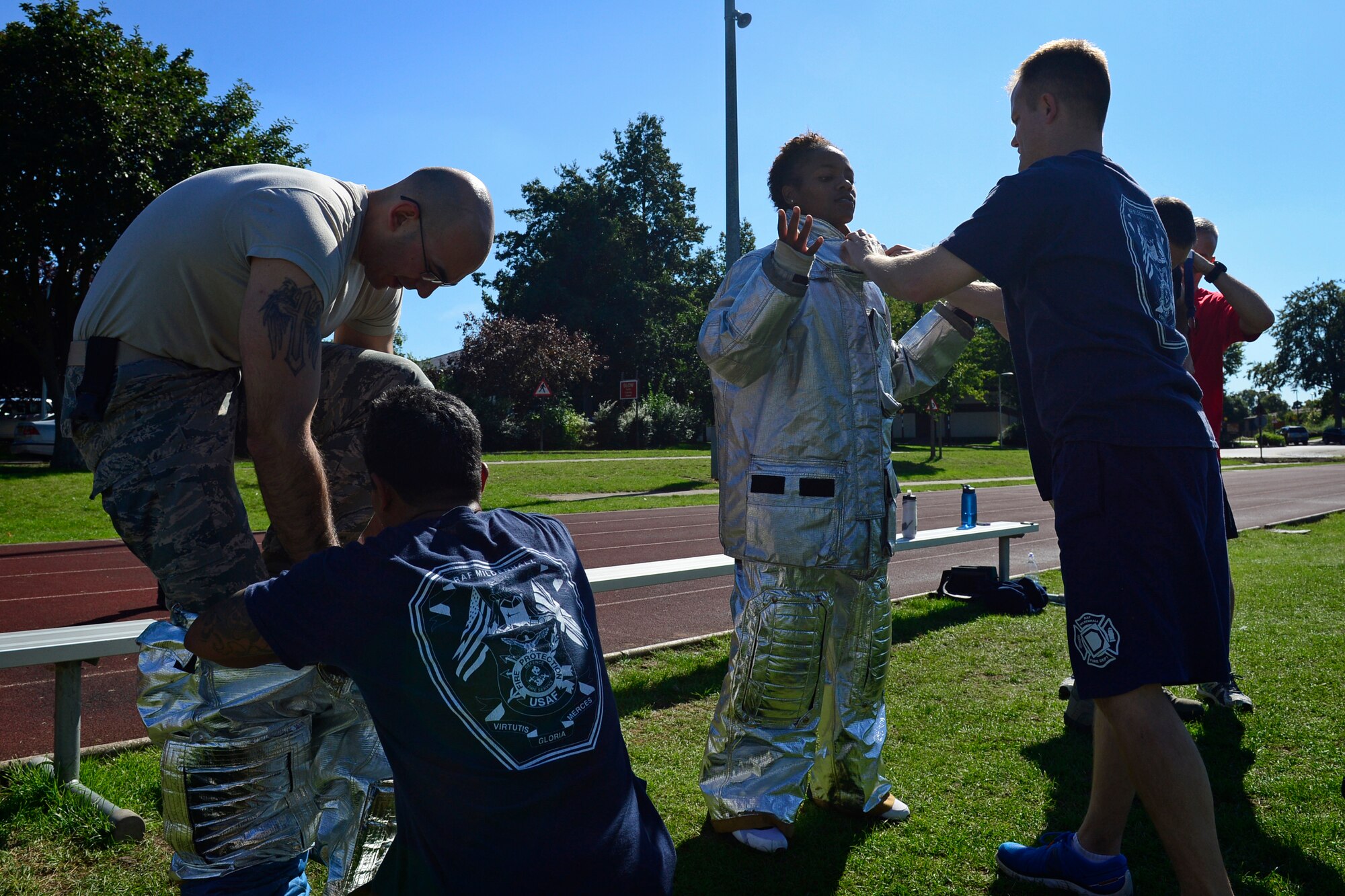 Team Mildenhall’s security forces don firefighting equipment as part of a relay event during the second annual Battle of the Badges at Royal Air Force Lakenheath, England, Sept. 10, 2015. The competition, comprised of four events, was designed to test the strength, endurance and agility of the first responders. (U.S. Air Force photo by Airman 1st Class Erin R. Babis/Released)