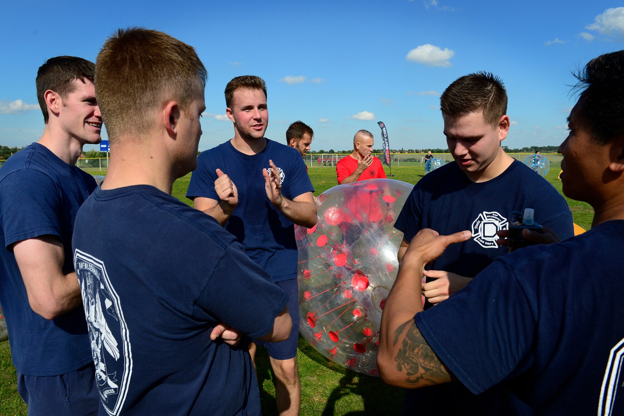 Team Mildenhall discusses Zorb soccer strategy during the second annual Battle of the Badges at Royal Air Force Lakenheath, England, Sept. 10, 2015. The competition, comprised of four events, was designed to test the strength, endurance and agility of the first responders. (U.S. Air Force photo by Airman 1st Class Erin R. Babis/Released)