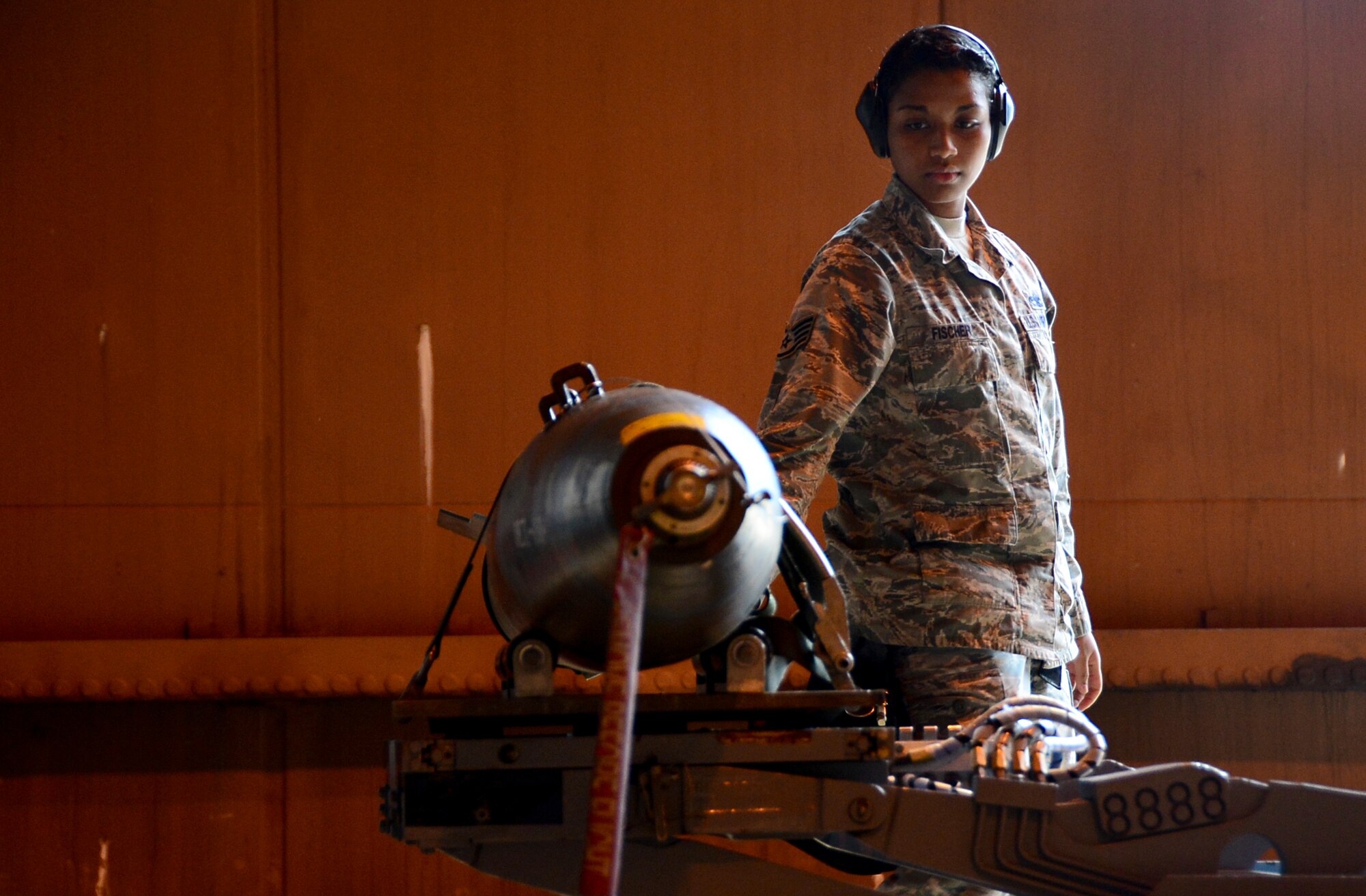 Staff Sgt. Jenean Fischer, 48th Aircraft Maintenance Squadron weapons load crew team chief, participates in a weapons standardization evaluation as a part of monthly training exercise at Royal Air Force Lakenheath, England, July 14, 2015. Weapons load crew Airmen are evaluated on their proficiency to load munitions onto an aircraft in a given time frame to prepare them for real world scenarios. (U.S. Air Force photo by Senior Airman Erin O’Shea/Released) 
