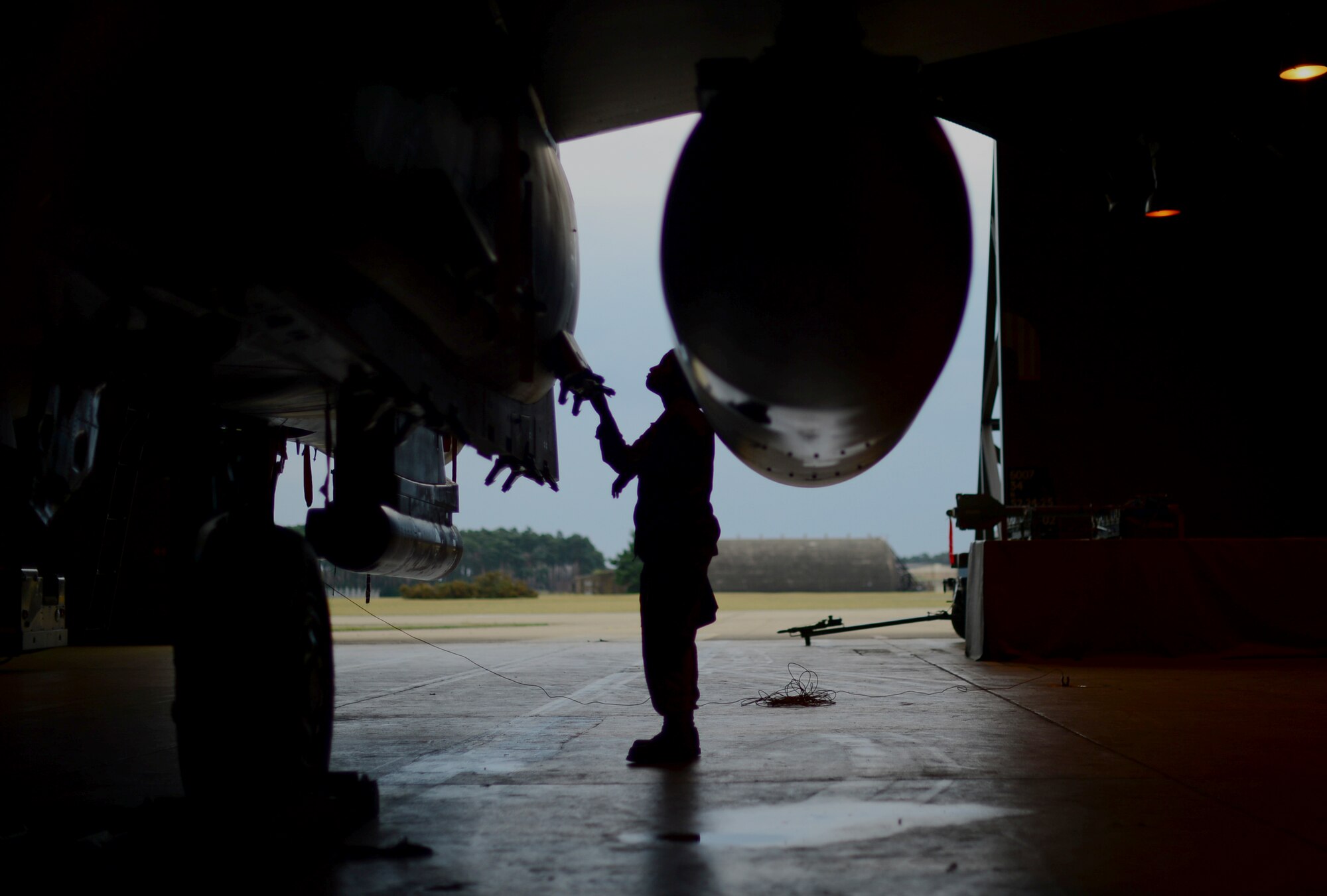 Staff Sgt. Jenean Fischer, 48th Aircraft Maintenance Squadron weapons load crew team chief, inspects a 494th Fighter Squadron F-15E Strike Eagle during a weapons standardization evaluation as a part of monthly training exercise at Royal Air Force Lakenheath, England, July 14, 2015. Weapons load crew Airmen are evaluated on their proficiency to load munitions onto an aircraft in a given time frame to prepare them for real world scenarios. (U.S. Air Force photo by Senior Airman Erin O’Shea/Released) 