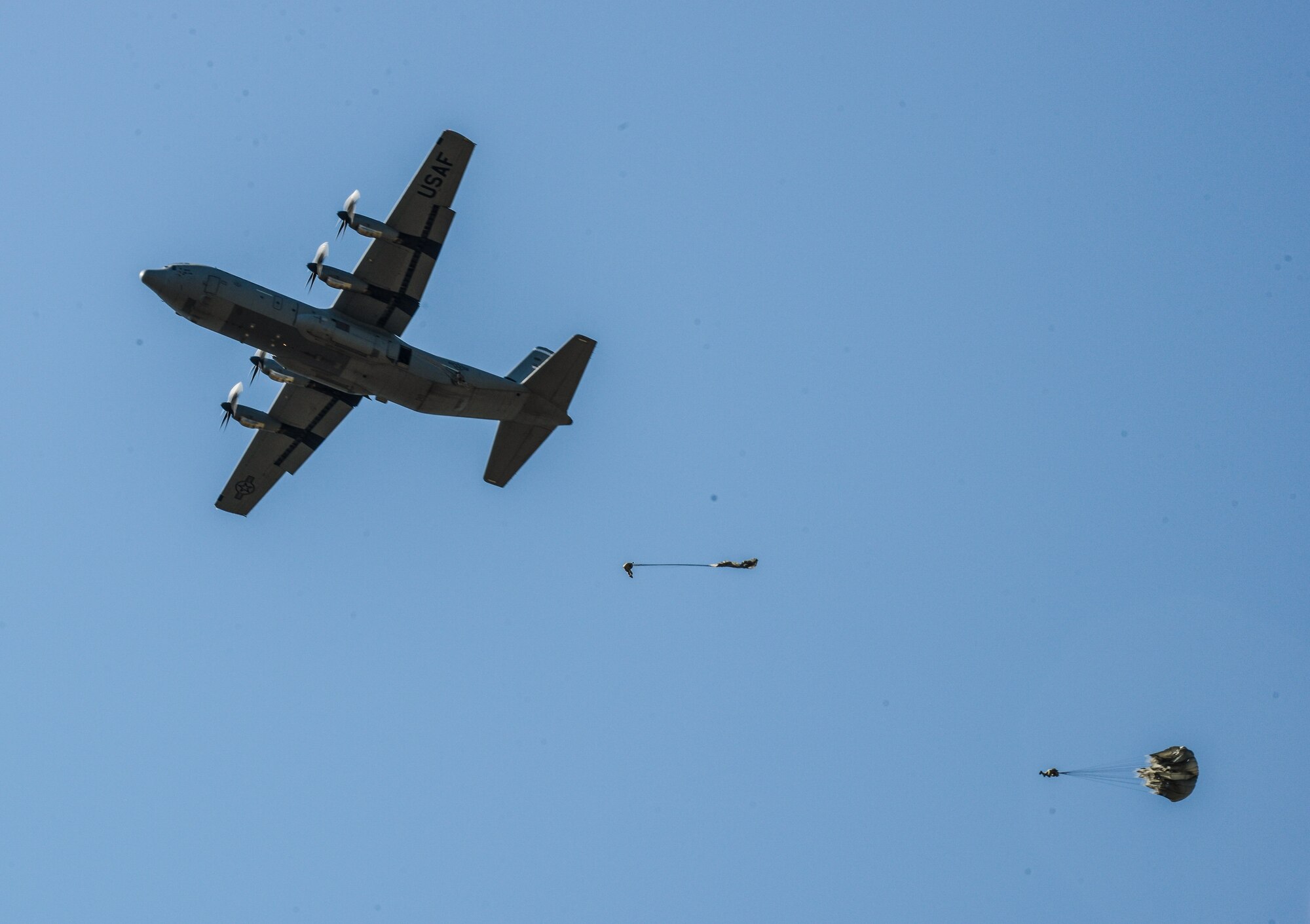 Airmen and Soldiers parachute from a C-130J Super Hercules over Alzey drop zone near Kaiserslautern, Germany, Aug. 31, 2015.  More than 20 Air Force independent duty medical technicians, security forces members and Army Special Forces paratroopers descended to the ground to quickly respond to a simulated medical emergency. (U.S. Air Force photo/Senior Airman Nicole Sikorski) 