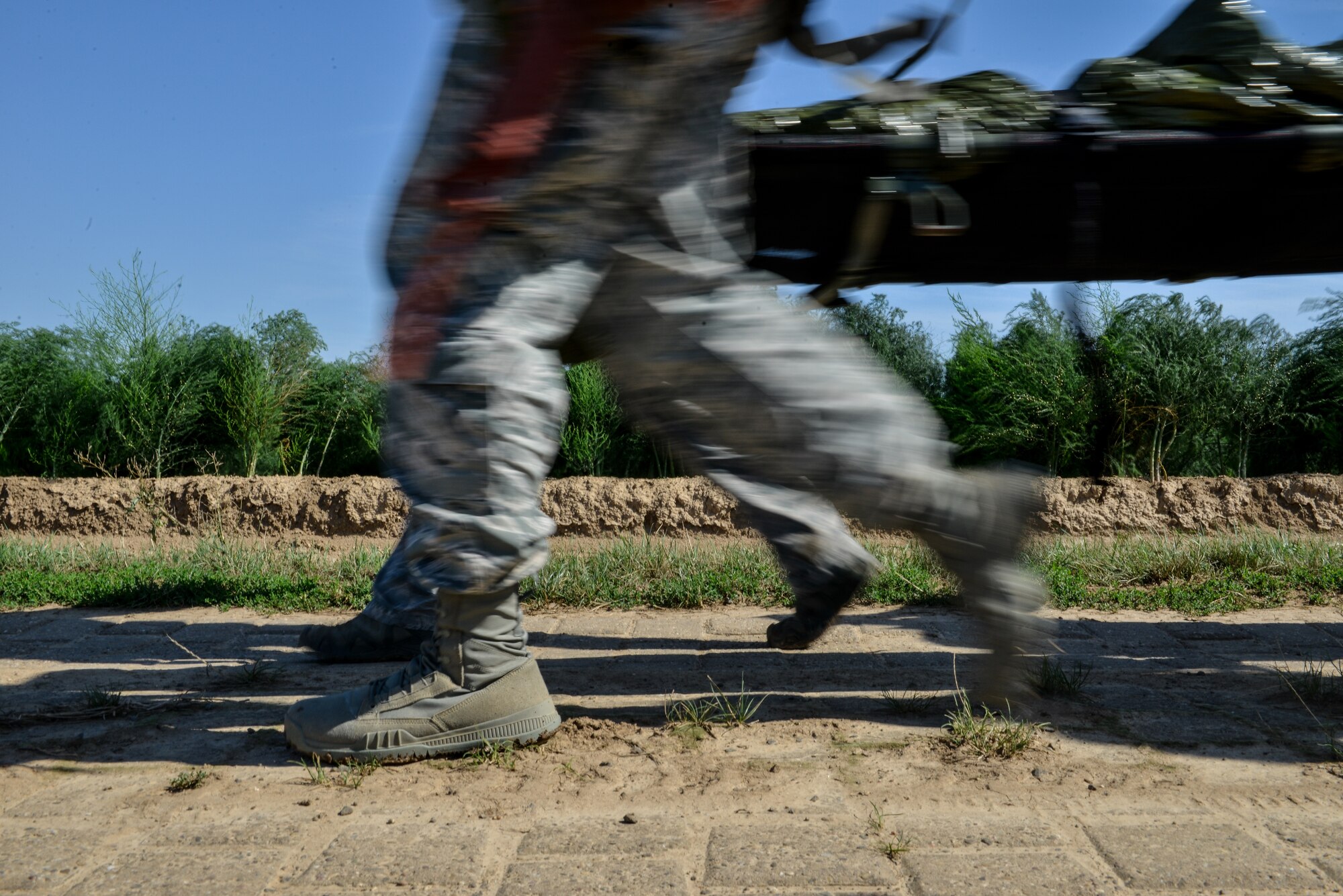 Airmen and Soldiers carry a simulated casualty to an ambulance at Alzey drop zone near Kaiserslautern, Germany, Aug. 31, 2015.  Joint forces worked together to rescue the casualty in a timely manner. The training was a component of Tactical Combat Casualty Care, which enhances contingency response abilities and first responder skills. (U.S. Air Force photo/Senior Airman Nicole Sikorski)