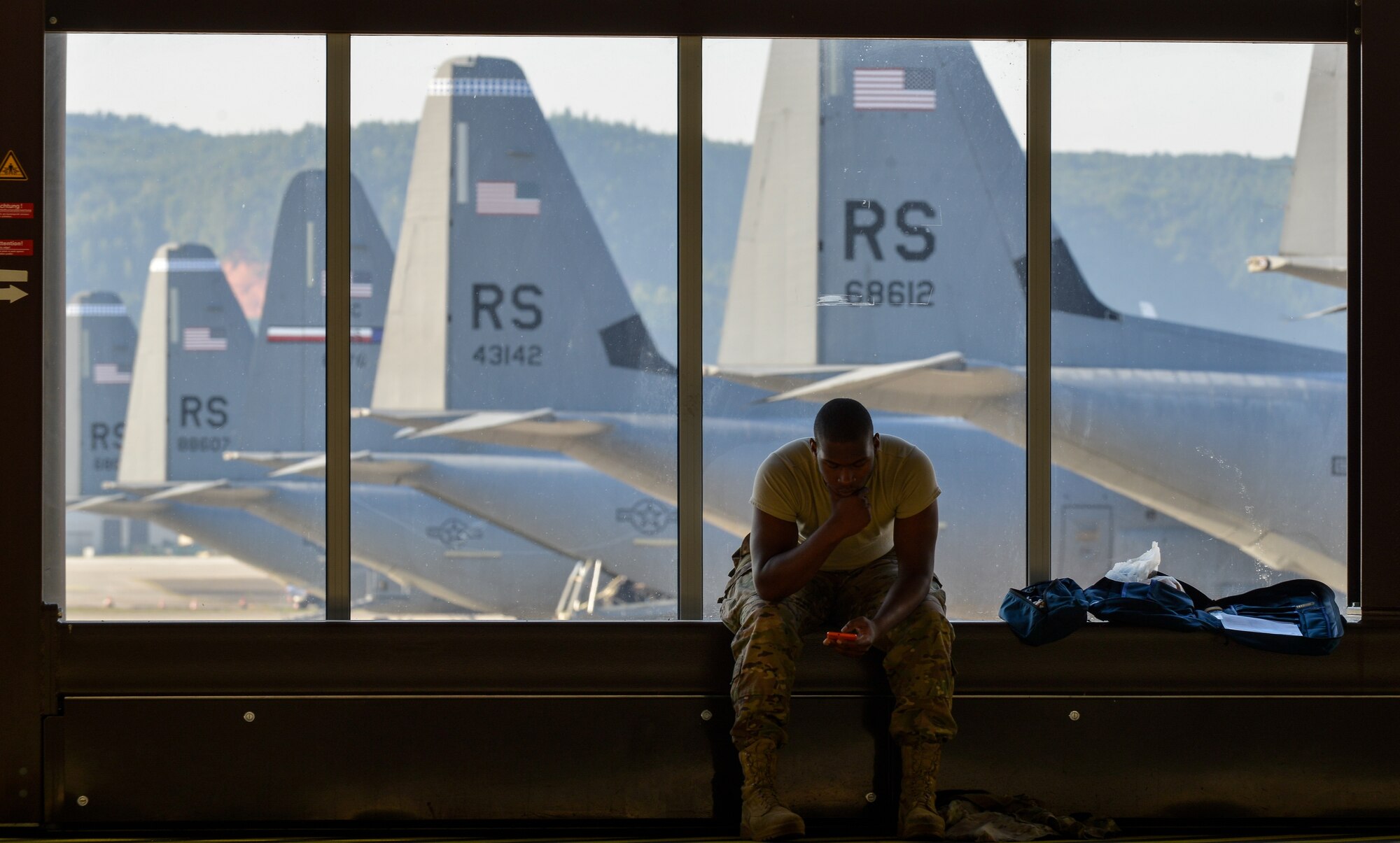 U.S. Army Spc. Ronald Garner, 5th Quarter Master Theater Aerial Delivery Company parachute rigger, waits to begin an airborne exercise at Ramstein Air Base, Germany, Aug. 31, 2015.  A U.S. Air Force C-130J Super Hercules transported more than 20 Air Force and Army paratroopers to Alzey drop zone, where they exited the aircraft to respond to a simulated medical emergency. (U.S. Air Force photo/Senior Airman Nicole Sikorski)