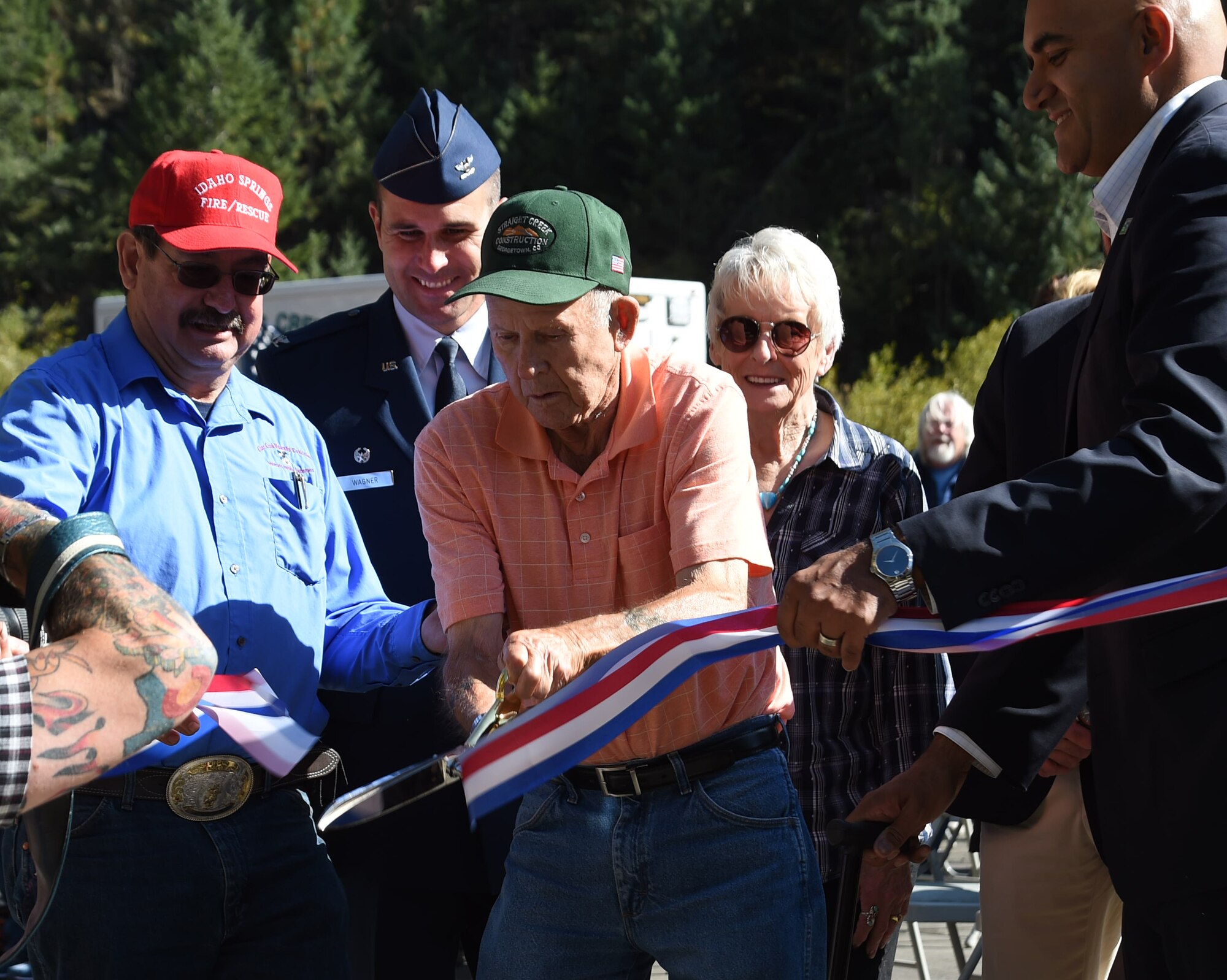 “Lefty” Yost, a Korean War veteran who helped build the original Twin Tunnels, cuts the ribbon during the Twin Tunnel re-naming ceremony Sept. 11, 2015, in Idaho Springs, Colo. Colorado State Legislature passed the bill in April 2015 to re-name the tunnels to recognize and remember the nation’s military veterans. (U.S. Air Force photo by Airman 1st Class Samantha Meadors/Released)