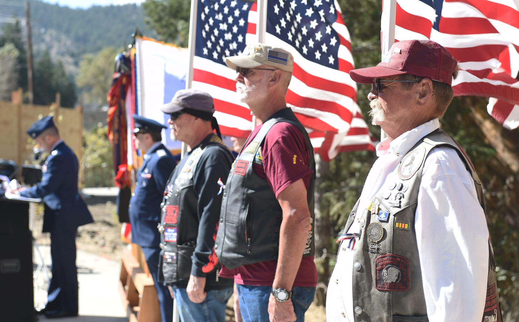 Colorado military veterans stand at attention while holding American Flags during the I-70 Twin Tunnel re-naming ceremony Sept. 11, 2015, in Idaho Springs, Colo. Colorado State Legislature passed the bill in April 2015 to re-name the tunnels to recognize and remember the nation’s military veterans. (U.S. Air Force photo by Airman 1st Class Samantha Meadors/Released)