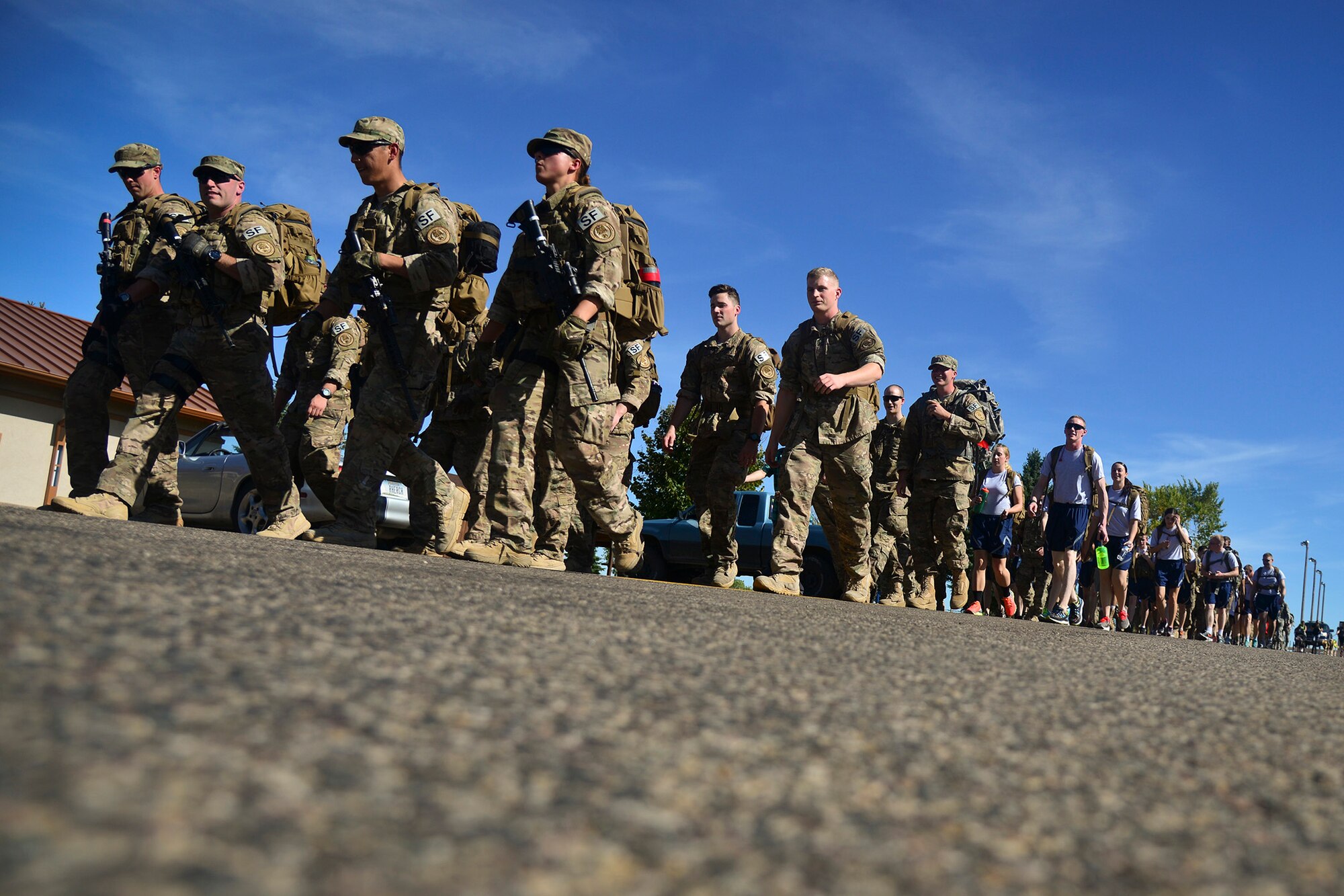 Airmen participate in a 5K Ruck March Sept. 11, 2015, at Malmstrom Air Force Base, Mont. The march began at the track and took a course around base that finished back at the track. The march helped pay respect to the men and women who lost their lives on Sept. 11, 2001. (U.S. Air Force photo/Airman Daniel Brosam)