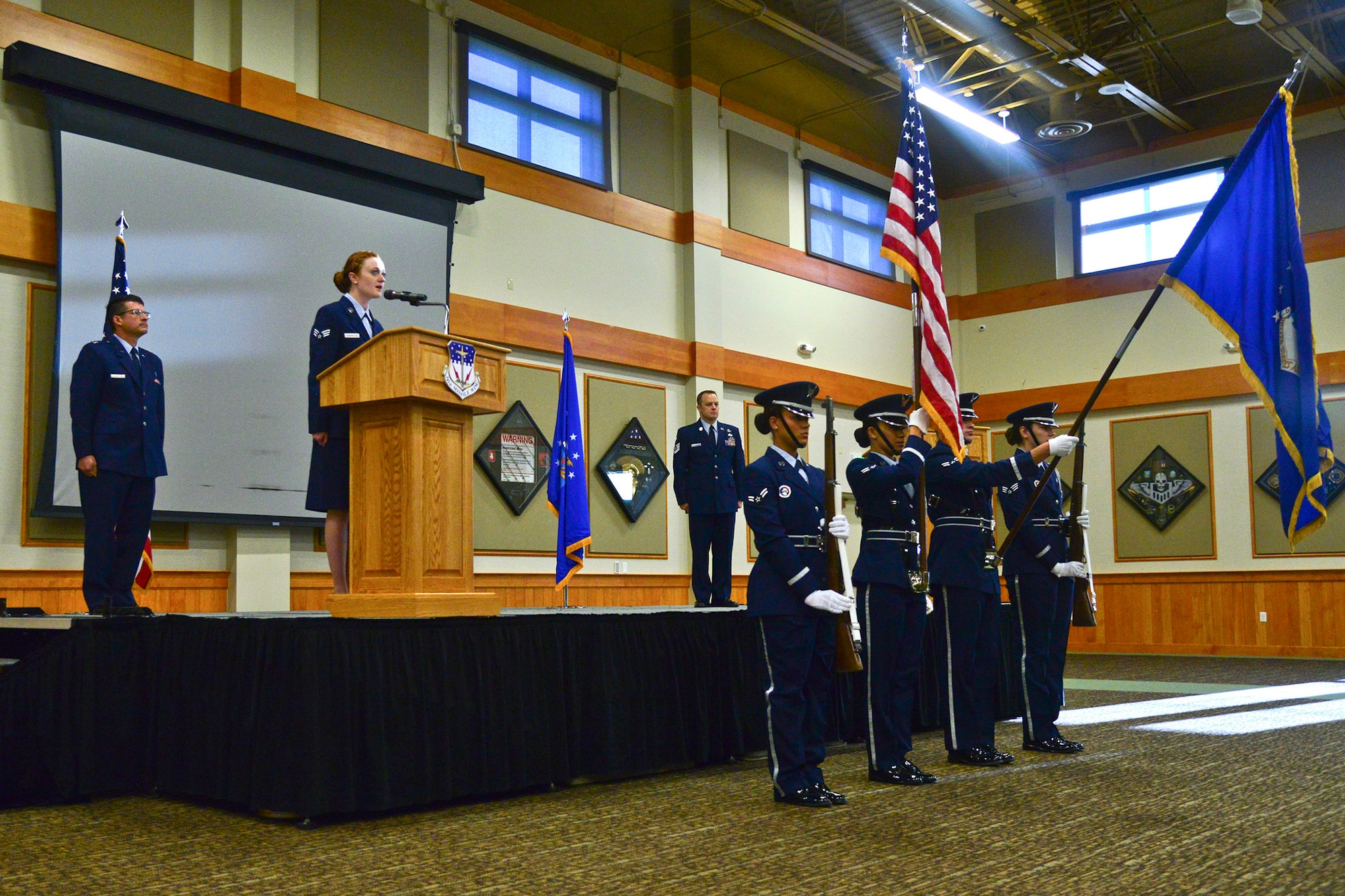 Senior Airman Courtney Youngblood, 341st Force Support Squadron food service journeyman, sings the national anthem during the presentation of the colors at Malmstrom Air Force Base, Mont. The ceremony was held to pay tribute to the victims of the terrorist attack on Sept. 11, 2001. (U.S. Air Force photo/Airman Daniel Brosam)