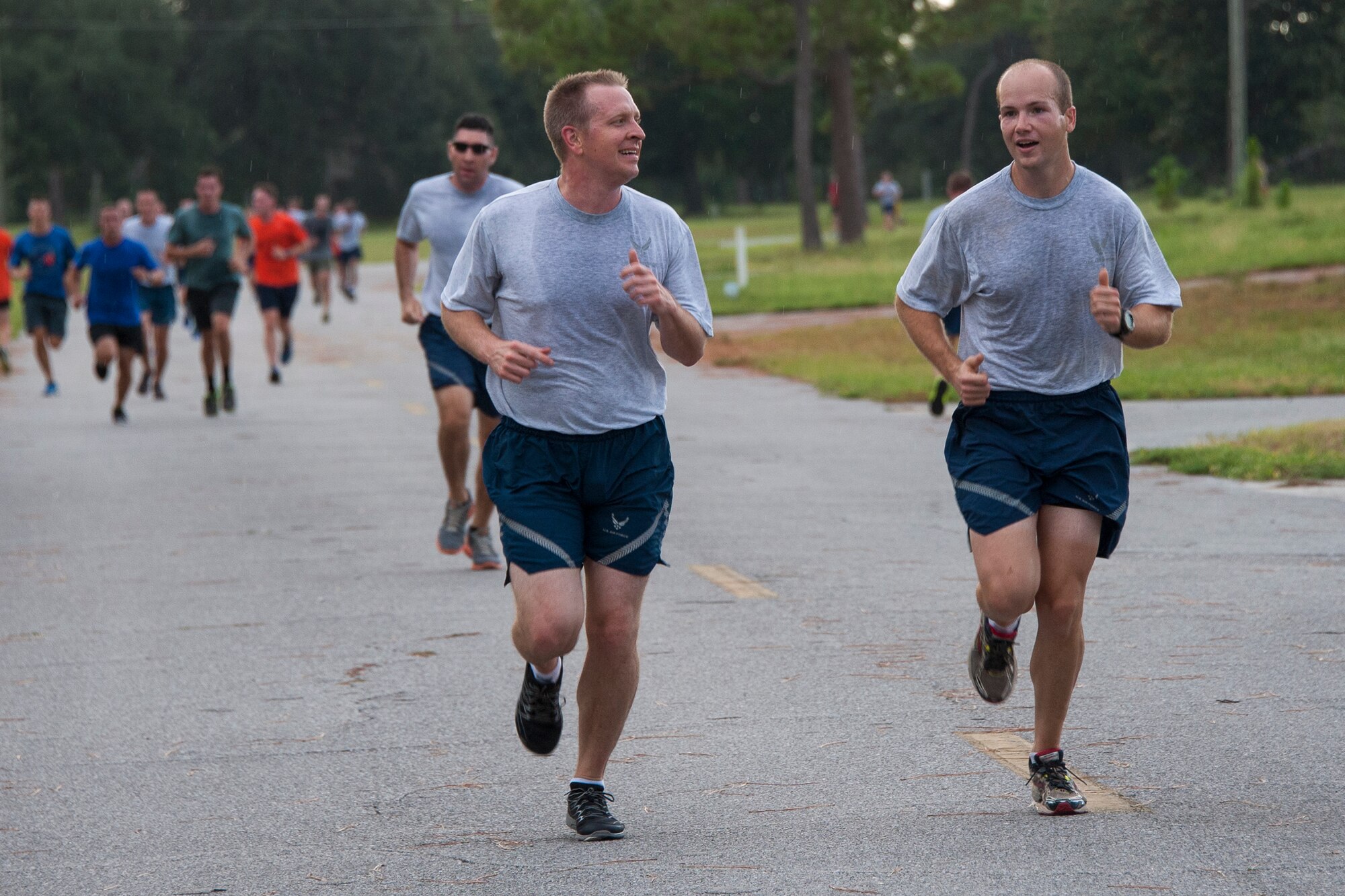 Airmen smile as they approach the finish line during the 9/11 Memorial 3-Mile Run/Walk at Eglin Air Force Base, Fla. Sept. 11. More than 535 runners participated in the run to remember the events of 9/11. (U.S. Air Force photo/Ilka Cole)