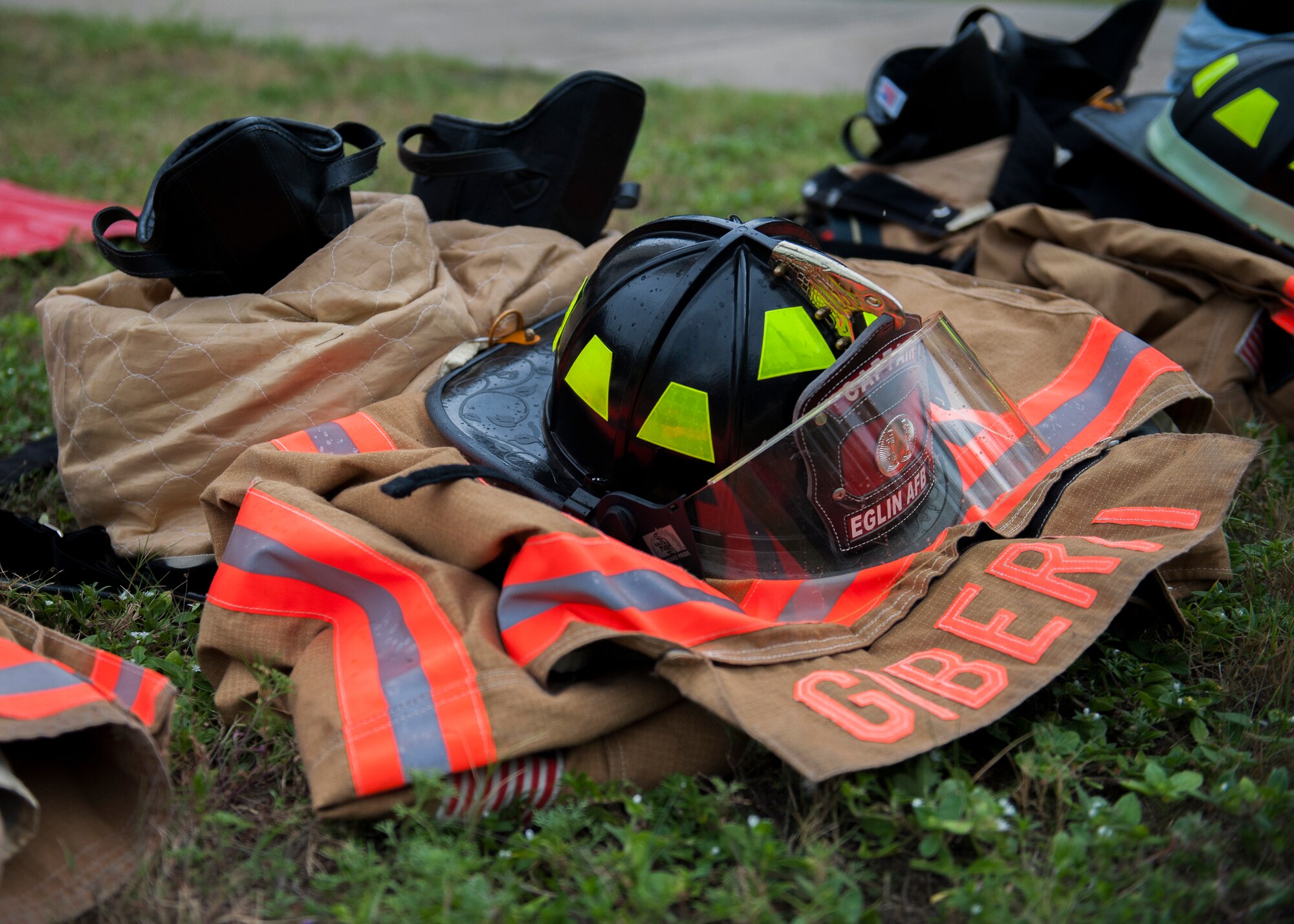 A firefighter 'bunker' protective equipment is ready to wear during the annual 9/11 memorial tower climb at Eglin Air Force Base, Fla., Sept. 11. Approximately 45 firefighters climbed 13 flights of steps with a name tag for each of the 343 firefighters who lost their lives 14 years ago. After reaching the top of the air traffic control tower, each name was recited and attached to a commemorative display board. The event closed with traditional bell rings and pauses between each ring to honor the 9/11 heroes. (U.S. Air Force photo/Ilka Cole) 
