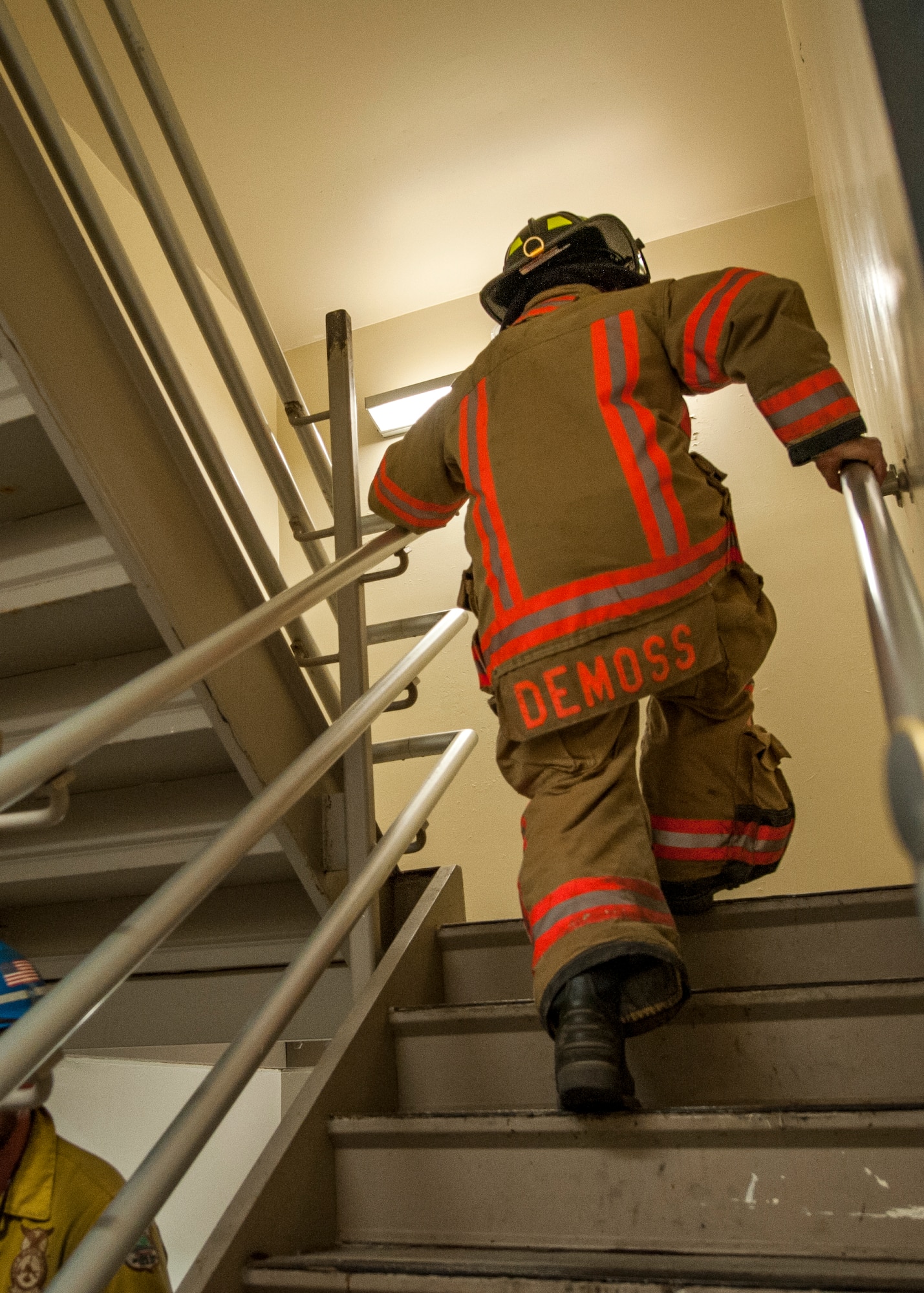 A 96th Civil Engineer Squadron firefighter, runs up the stairs of the air traffic control tower during the annual 9/11 memorial tower climb at Eglin Air Force Base, Fla., Sept. 11. 
Approximately 45 firefighters climbed 13 flights of steps with a name tag for each of the 343 firefighters who lost their lives 14 years ago. After reaching the top of the air traffic control tower, each name was recited and attached to a commemorative display board. The event closed with traditional bell rings and pauses between each ring to honor the 9/11 heroes. (U.S. Air Force photo/Ilka Cole)