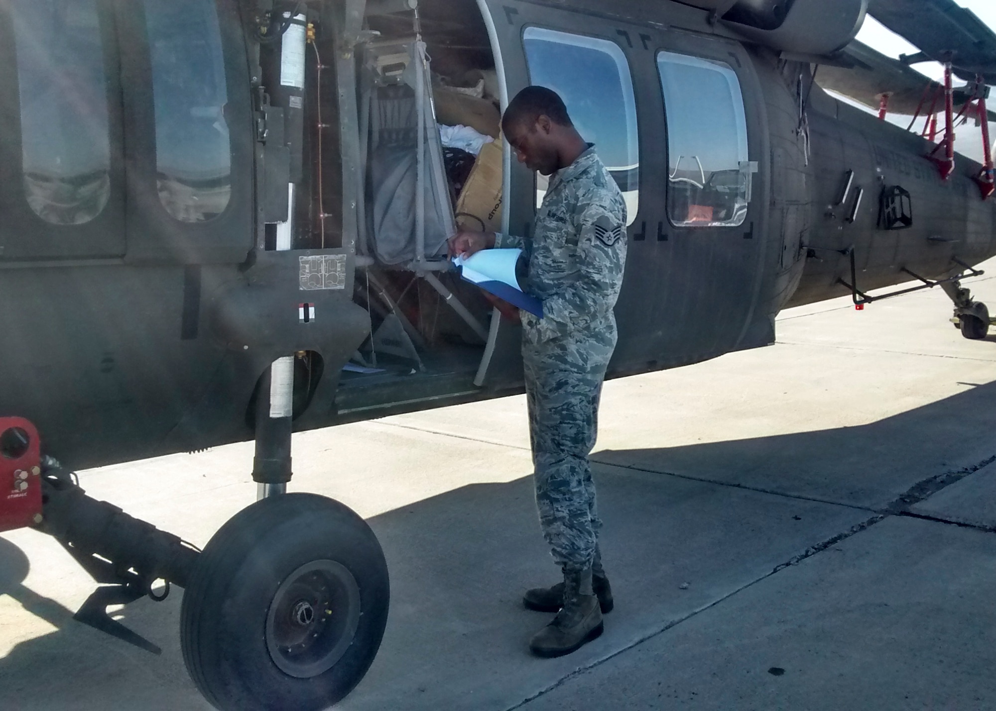Staff Sgt. Johnathan Barnes, 412th Logistics Readiness Squadron, inspects an Army National Guard UH-60 Blackhawk helicopter prior to loading it on a C-17 for cross-country transport. (Courtesy photo)