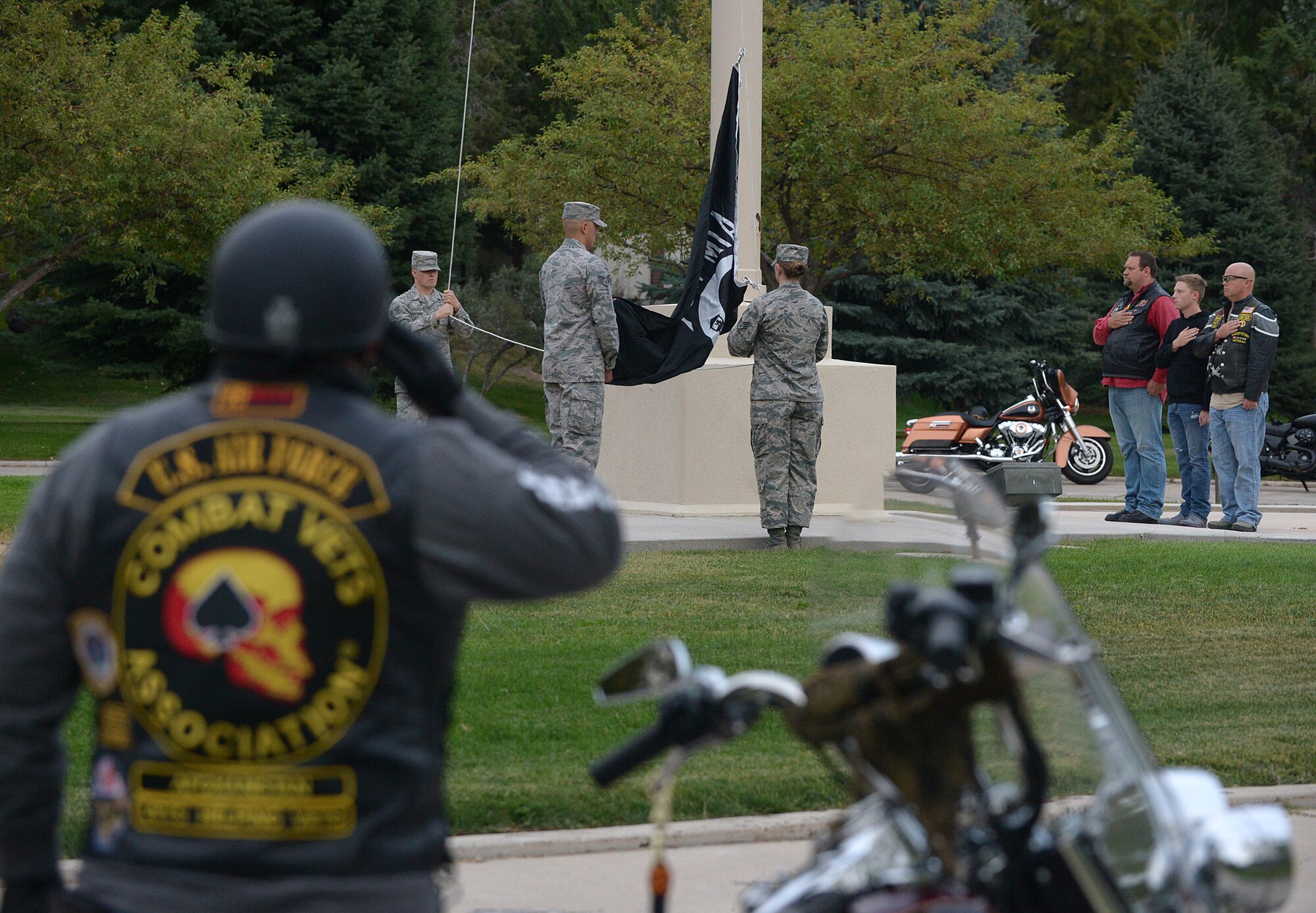 Combat Veterans Association members show respect as 75th Air Base Wing Honor Guard members prepare to raise a POW/MIA flag during a reveille ceremony held in front of the wing headquarters building at Hill Air Force Base, Utah, Sept. 14, 2015. The reveille ceremony is the first event to be held on the base in observance of National POW/MIA Memorial Week.  (U.S. Air Force photo by Alex R. Lloyd/Released)