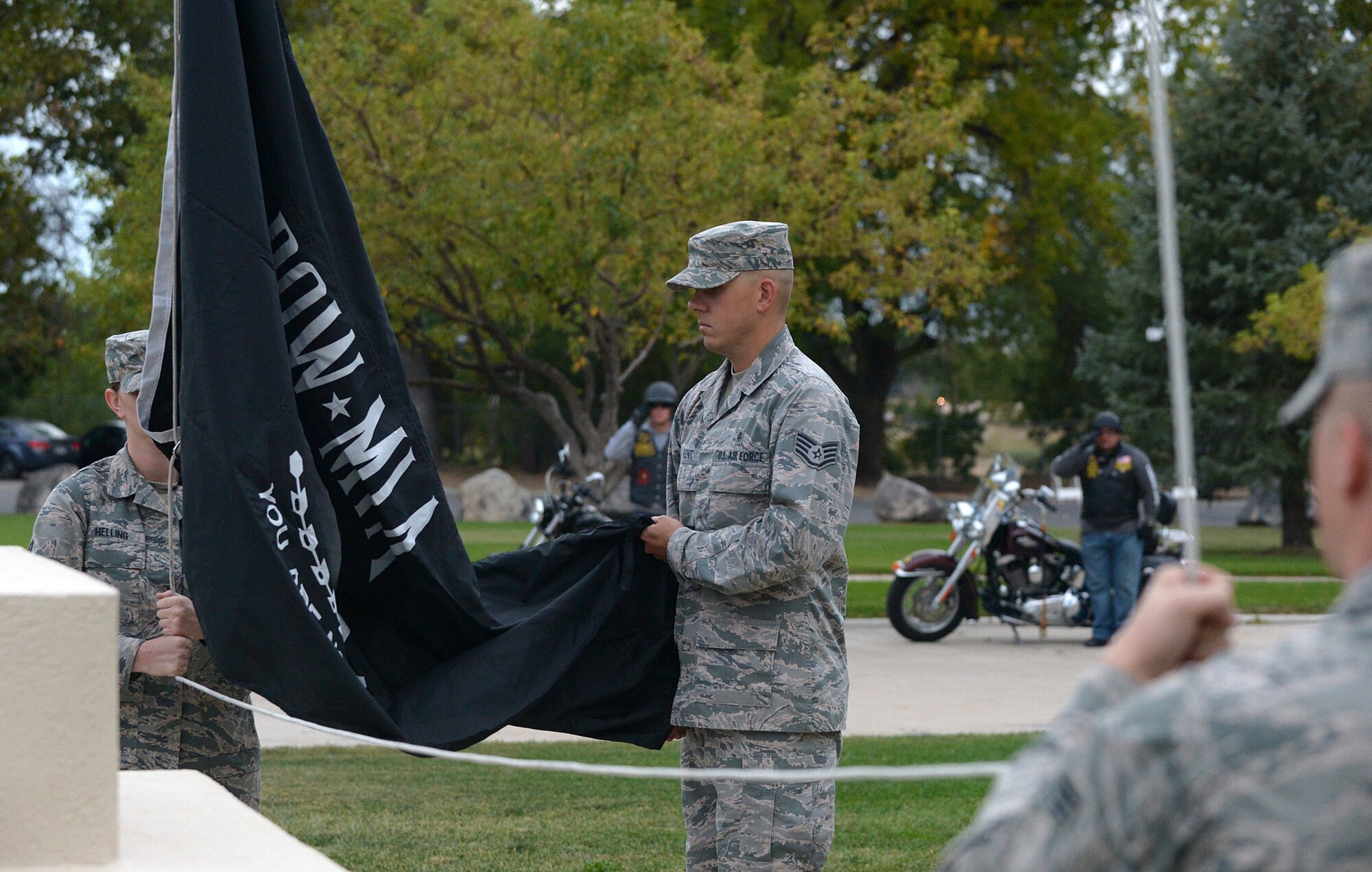 75th Air Base Wing Honor Guard members Staff Sergeants Monica Helling and Justin Kent raise a POW/MIA flag during a reveille ceremony held in front of the wing headquarters building at Hill Air Force Base, Utah, Sept. 14, 2015. The reveille ceremony is the first event to be held on the base in observance of National POW/MIA Memorial Week.  (U.S. Air Force photo by Alex R. Lloyd/Released)