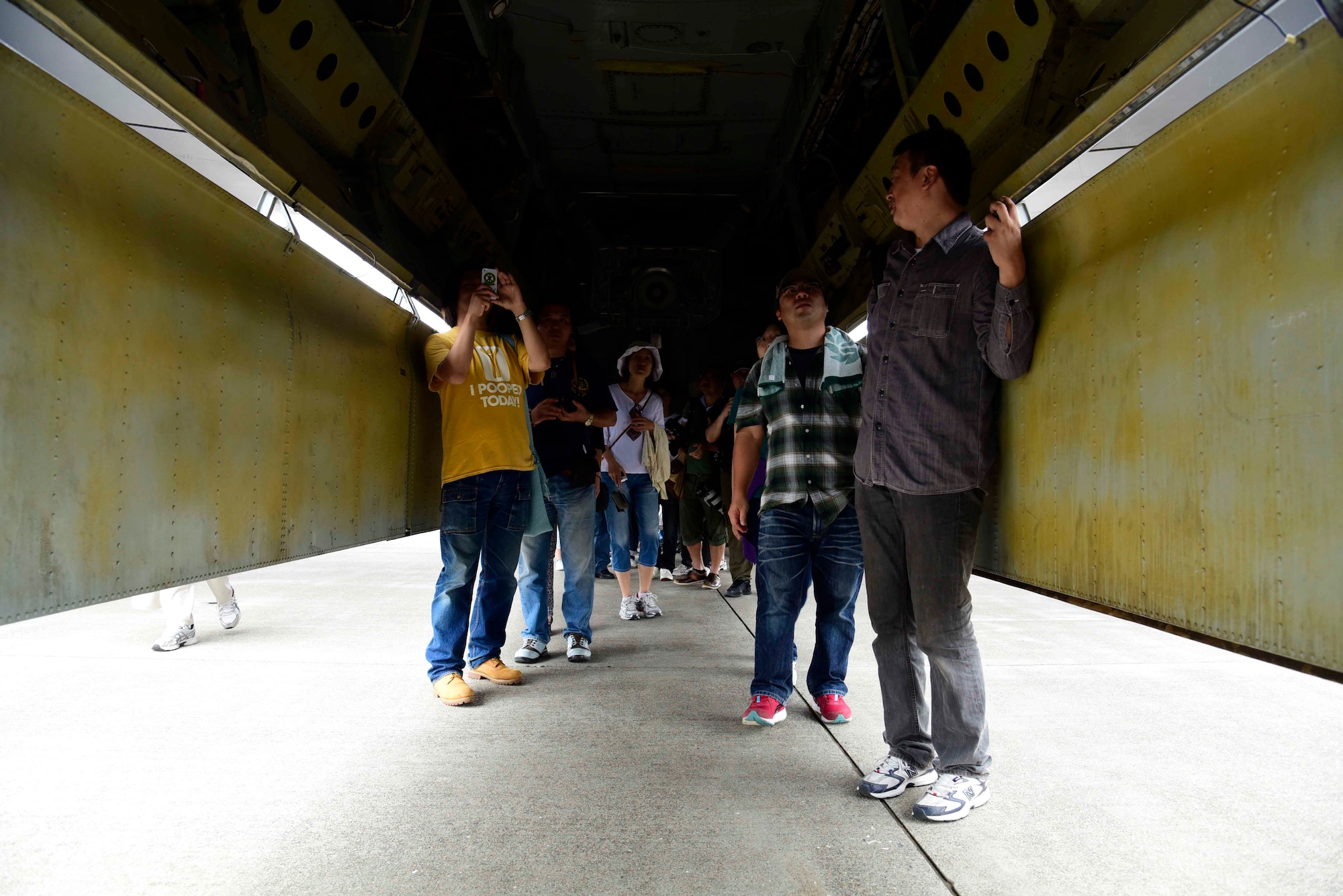 Misawa Air Festival attendees explore the underside of a B-52 Stratofortress at Misawa Air Base, Japan, Sept. 13, 2015. This aircraft is a long-range, heavy bomber capable of precision guided conventional ordnance in offensive counter-air and maritime operations. (U.S. Air Force photo by Airman 1st Class Jordyn Fetter/Released)