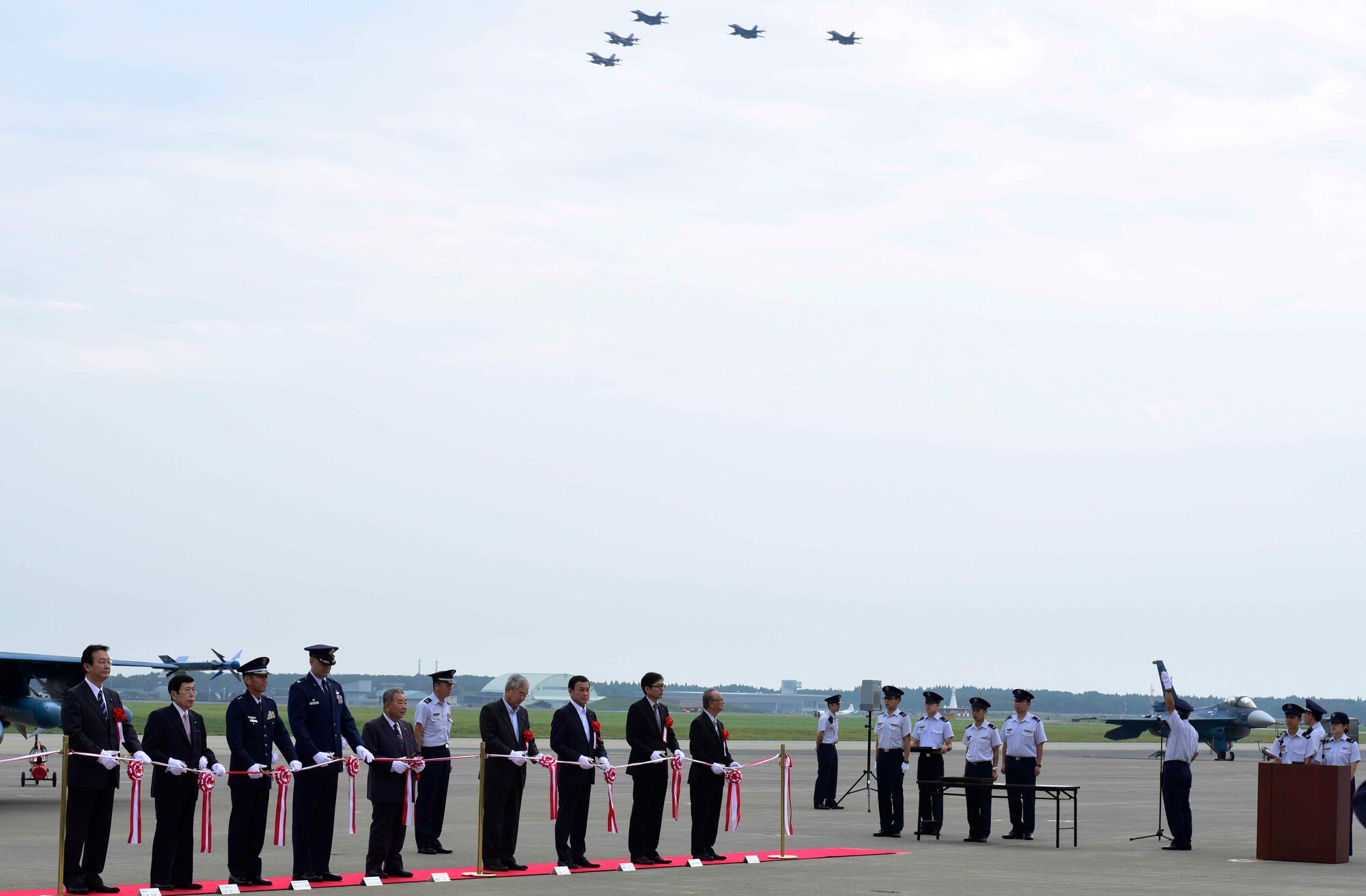 Misawa Air Base and local civic leadership conduct the Air Festival opening ceremony at Misawa AB, Japan, Sept. 13, 2015. The ceremony concluded with a flyby of multiple aircraft and the cutting of a ribbon. (U.S. Air Force photo by Airman 1st Class Jordyn Fetter/Released)