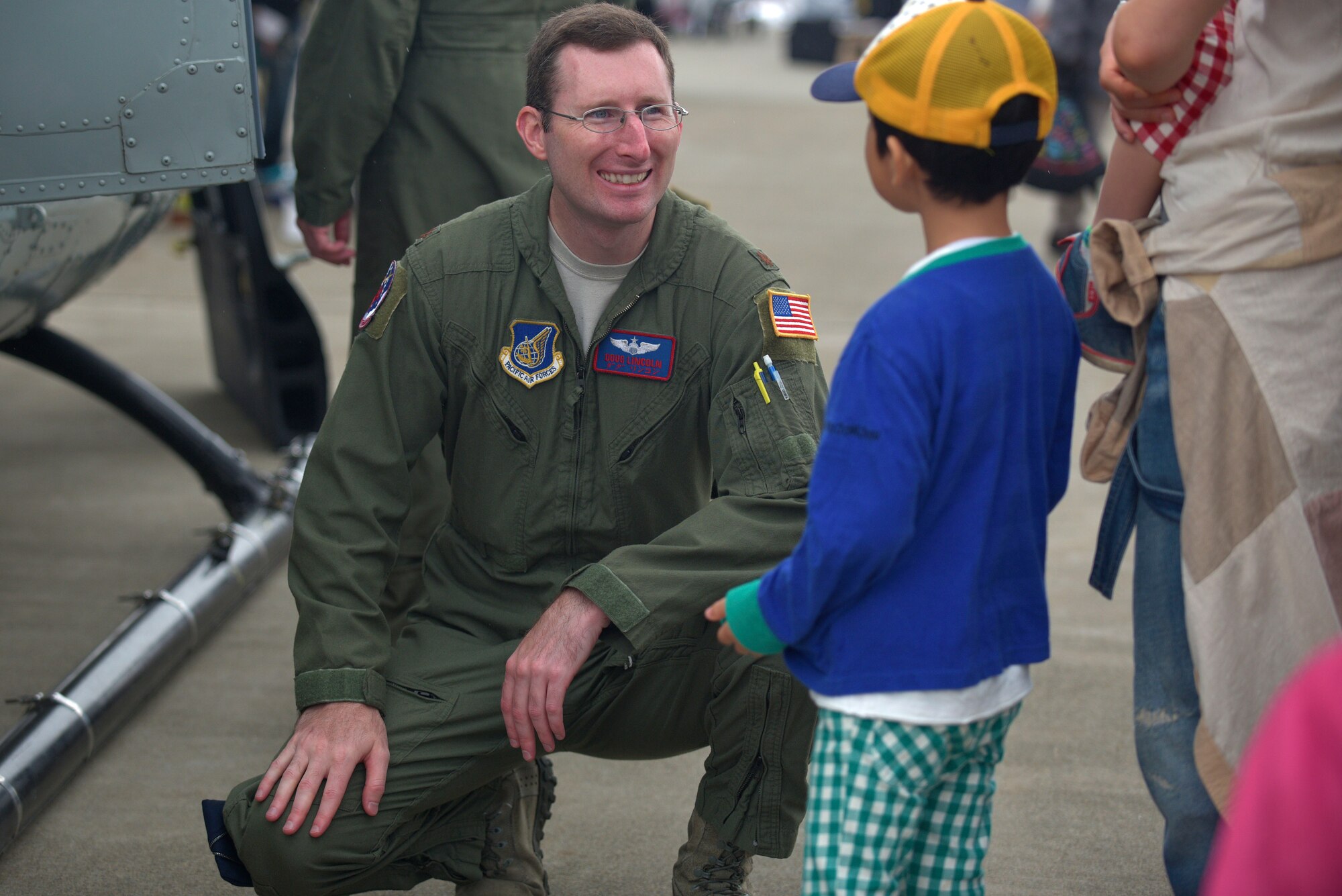 U.S. Air Force Maj. Doug Lincoln, 459th Airlift Squadron pilot, interacts with an Air Festival attendee at Misawa Air Base, Japan, Sept. 13, 2015. The festival served as a way for the local community to interact with American service members and learn about both Japanese and American aircraft. (U.S. Air Force photo by Senior Airman Jose L. Hernandez-Domitilo/Released) 