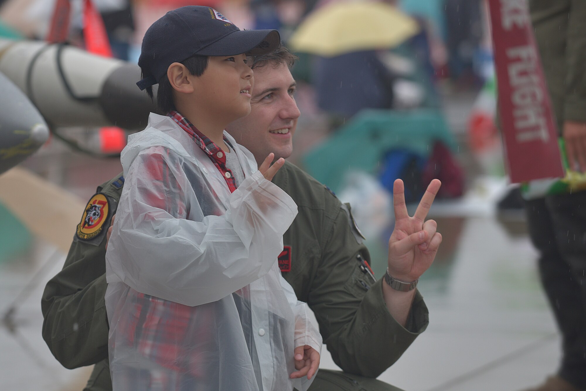 U.S. Air Force Capt. Alexander Vane, 13th Fighter Squadron pilot, poses with an Air Festival attendee at Misawa Air Base, Japan, Sept. 13, 2015. The local community interacted with pilots and asked questions to learn more about the aircraft they fly. (U.S. Air Force photo by Senior Airman Jose L. Hernandez-Domitilo/Released)