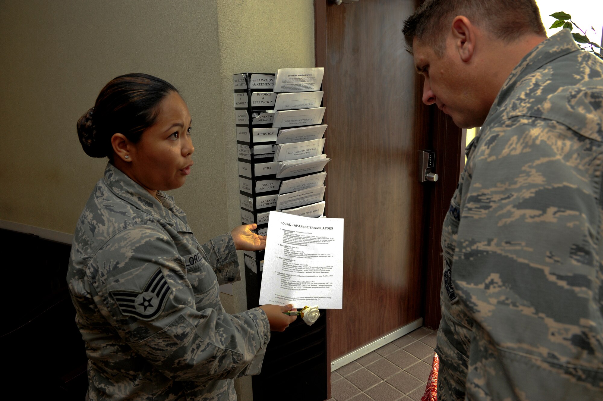 Staff Sgt. Edrianne Flores-Tullis, 18th Wing Judge Advocate, tells Col. Christopher Amrhein, 18th Wing vice commander, the resources available to Airmen provided by the legal office in support of Project 22 Sept. 14, 2015 at Kadena Air Base, Japan. Twenty nine units from Kadena and Torii Station are taking part in Project 22 to raise awareness about the resources available to mitigate the risk of suicide. (U.S. Air Force photo by Airman 1st Class Corey M. Pettis)    