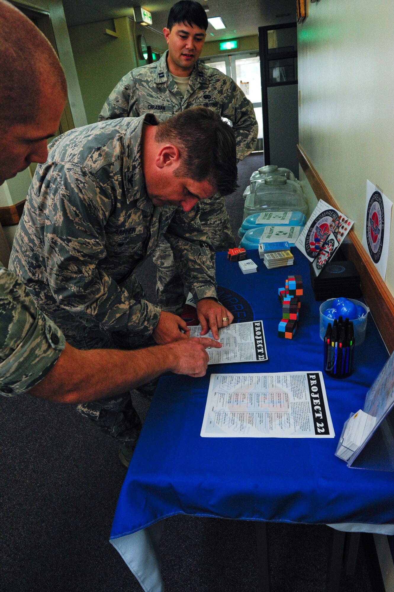 Capt. Levi Cole, 18th Medical Operations Squadron psychologist, shows Col. Christopher Amrhein, 18th Wing vice commander, a Project 22 worksheet at the equal opportunity office Sept. 14, 2015 at Kadena Air Base, Japan. The goal of Project 22 is to show Airmen all of the different resources available to them. (U.S. Air Force photo by Airman 1st Class Corey M. Pettis)