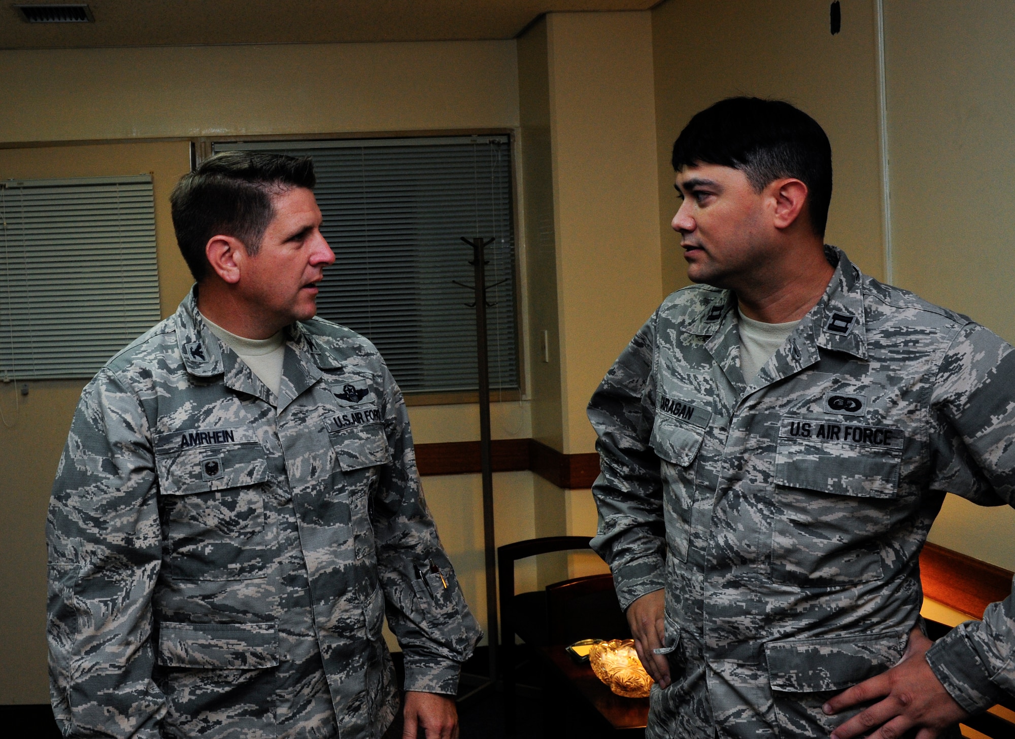Capt. Joshua Caragan, 18th Wing equal opportunity officer, talks to Col. Christopher Amrhein, 18th Wing vice commander, about the resources provided by the equal opportunity office in support of Project 22 Sept. 14, 2015 at Kadena Air Base, Japan. Project 22 is a suicide prevention initiative challenging Airmen to find out what resources are available to them around the base. (U.S. Air Force photo by Airman 1st Class Corey M. Pettis)    