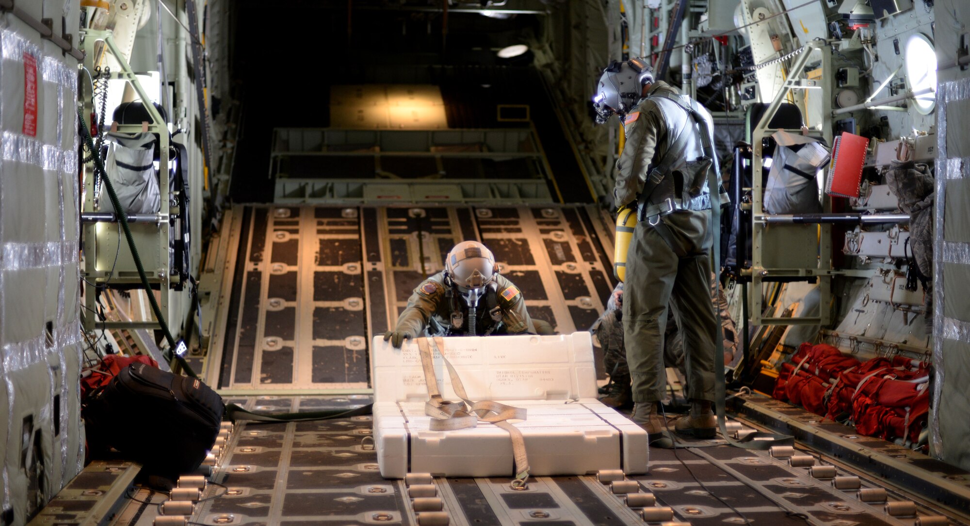 U.S. Air Force Senior Airman Jeremie Anderson, left, 67th Special Operations Squadron MC-130J Commando II loadmaster, and U.S. Air Force Capt. Todd Bourgeois, 67th SOS Wing Executive Officer and Aircraft Commander, inspect LUU-4/B flares during a training mission Sept. 8, 2015, over the North Sea. The 67th SOS and the 48th Fighter Wing organized the two-day mission in order to provide realistic targeting training for F-15 pilots. Although the primary use of the flares are for search and rescue missions, instead they were used for targeting practice due to their upcoming expiration date. (U.S. Air Force photo by Tech. Sgt. Austin May/Released