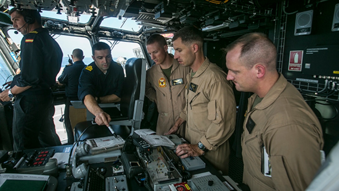 U.S. Marine pilots with Special-Purpose Marine Air-Ground Task Force Crisis Response-Africa, coordinate air movements with the Spanish Navy aboard Spanish amphibious assault ship Juan Carlos I (L-61) during deck landing qualifications, Sept. 9 near the coast of Spain. This training proved the ability of a tiltrotor aircraft, like the Osprey, to land on the deck of the Spanish ship.