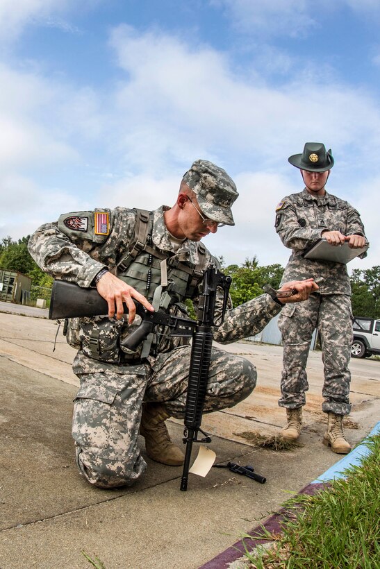 Army Staff Sgt. Mark Mercer, foreground, reassembles an M-16A2 rifle during the Army Training and Doctrine Command Drill Sergeant of the Year competition on Fort Jackson, S.C., Sept. 8, 2015. Mercer, a Reserve drill sergeant assigned to the 98th Training Division, is in a head-to-head competition with Army Staff Sgt. Russell Vidler. U.S. Army photo by Sgt. 1st Class Brian Hamilton 