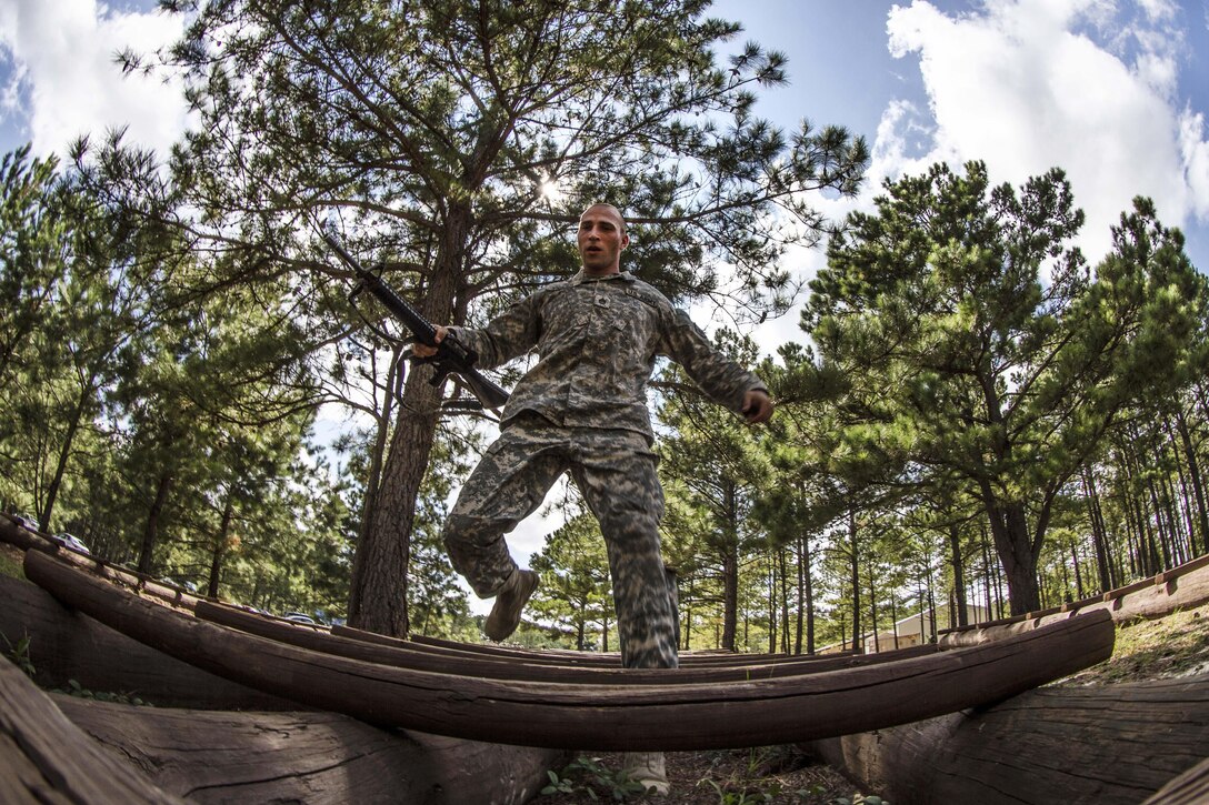 Army Staff  Sgt. Russell Vidler maneuvers over logs at the Fit to Win obstacle course during the Army Training and Doctrine Command Drill Sergeant of the Year competition on Fort Jackson, S.C., Sept. 9, 2015. Vidler is a Reserve drill sergeant assigned to the 98th Training Division. U.S. Army photo by Sgt. 1st Class Brian Hamilton 