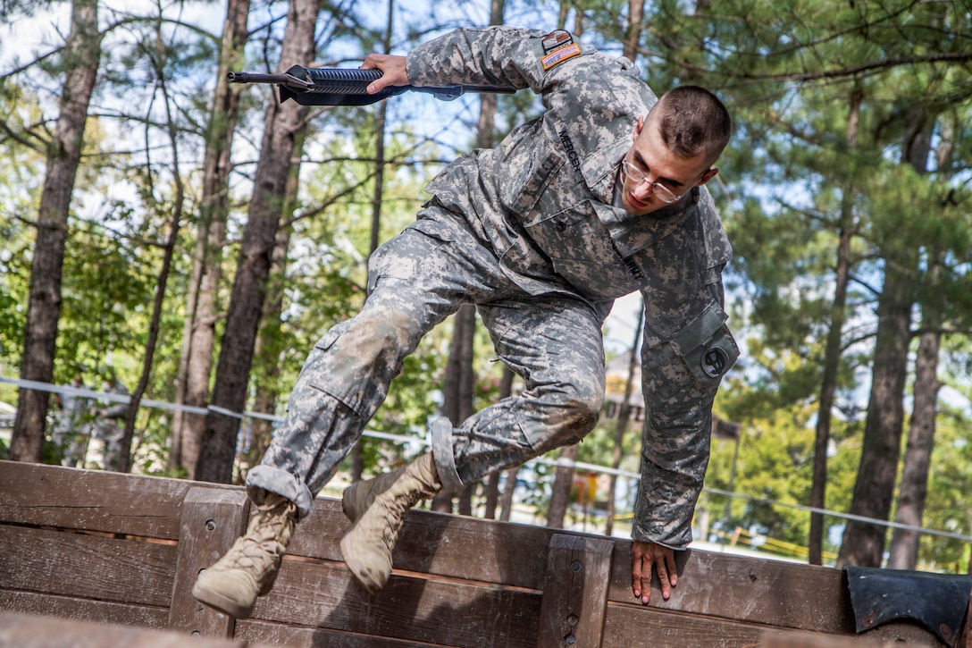 Army Staff Sgt. Mark Mercer leaps over the high wall at the Fit to Win obstacle course during the Army Training and Doctrine Command Drill Sergeant of the Year competition on Fort Jackson, S.C., Sept. 9, 2015. Mercer is a Reserve drill sergeant assigned to the 98th Training Division. U.S. Army photo by Sgt. 1st Class Brian Hamilton