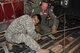 Army Spc. Bach Dong, a mechanic, both in the 890th Engineering Battalion, and Air Force Master Sgt. Joshua Stanton, a loadmaster in the 815th Airlift Squadron work together to tie down a military ambulance into the cargo area of a C-130J aircraft.  The Air Force Reserve, the Air National Guard and the Army National Guard teamed up for a joint training scenario called Joint Conquest here and at the Gulfport Combat Readiness Training Center, Mississippi Sept. 11-13. (U.S. Air Force Photo/Master Sgt. Jessica Kendziorek) 