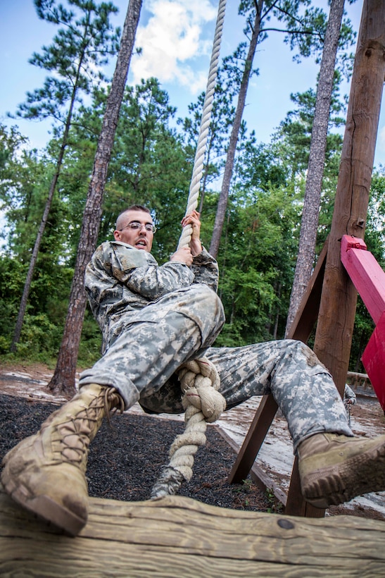 Army Staff Sgt. Mark Mercer swings to a high wall at the Fit to Win obstacle course during the Army Training and Doctrine Command Drill Sergeant of the Year competition on Fort Jackson, S.C., Sept. 9, 2015. Mercer is a Reserve drill sergeant assigned to the 98th Training Division. U.S. Army photo by Sgt. 1st Class Brian Hamilton 