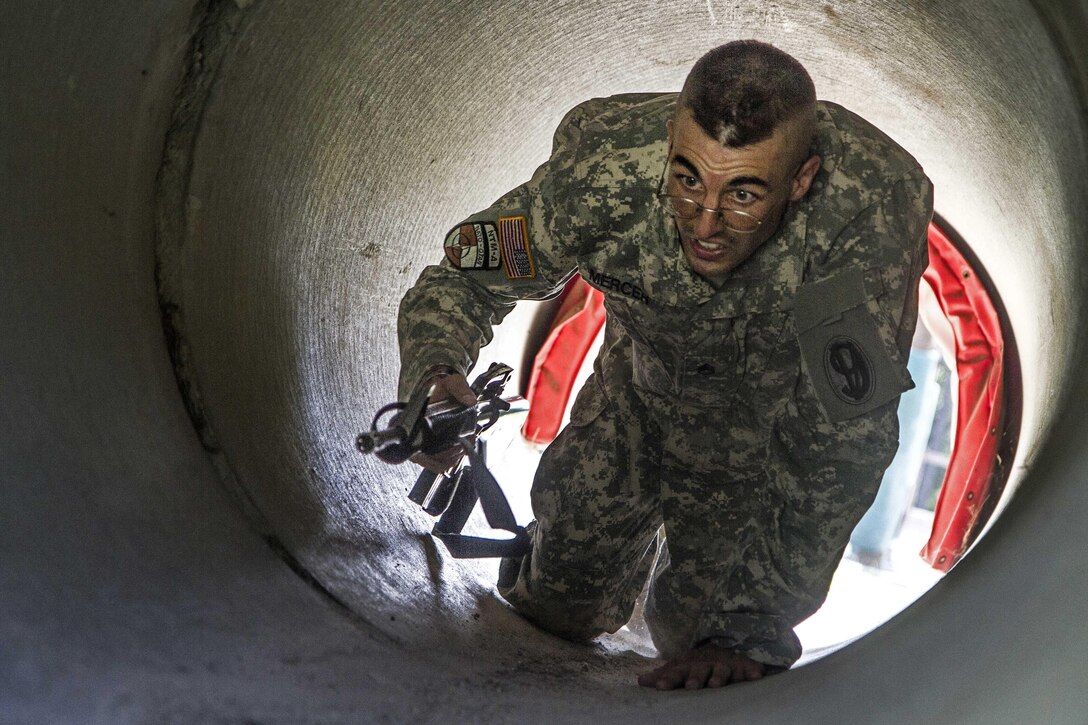 Army Staff Sgt. Mark Mercer crawls through a drainage culvert at the Fit to Win obstacle course during the Army Training and Doctrine Command Drill Sergeant of the Year competition on Fort Jackson, S.C., Sept. 9, 2015. Mercer is a Reserve drill sergeant assigned to the 98th Training Division. U.S. Army photo by Sgt. 1st Class Brian Hamilton