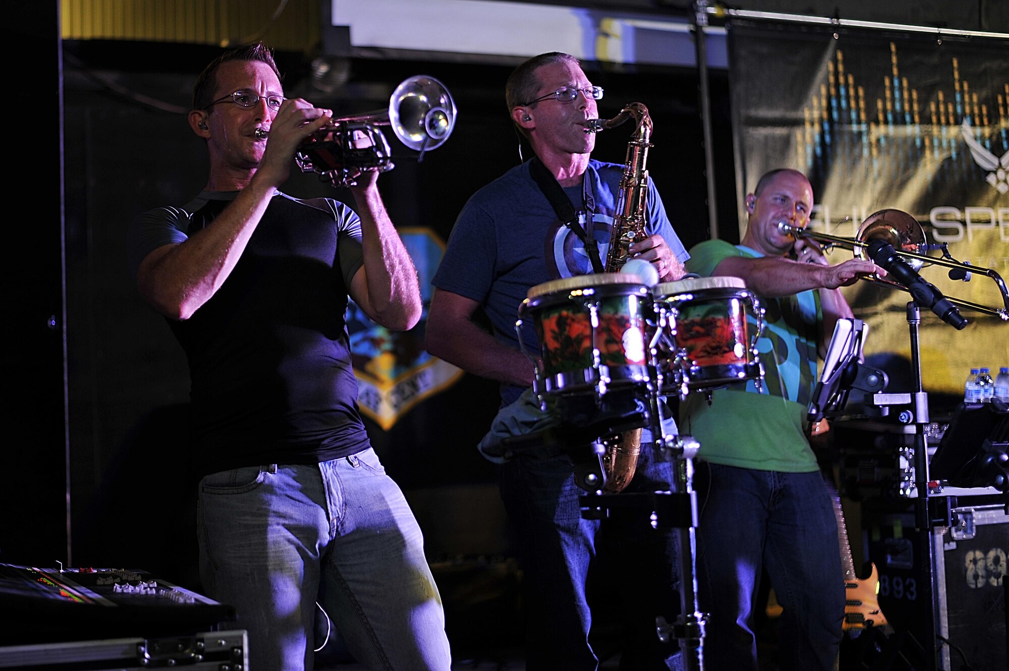The Air Forces Central Command band horn section, perform for service members during a concert at an undisclosed location in Southwest Asia, Aug. 28, 2015. The AFCENT band is composed of musicians who perform and tour throughout the Central Command Area of Responsibility to encourage troop morale, diplomacy and outreach to host nation communities. (U.S. Air Force photo by Staff Sgt. Emerson Nuñez/Released)
