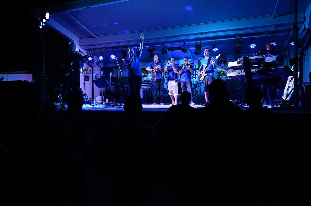 Air Forces Central Command band members entertain service members during a performance at an undisclosed location in Southwest Asia, Aug. 29, 2015. The AFCENT band is composed of musicians who perform and tour throughout the area of responsibility to encourage troop morale, diplomacy and outreach to host nation communities. (U.S. Air Force photo by Staff Sgt. Emerson Nuñez/Released)
