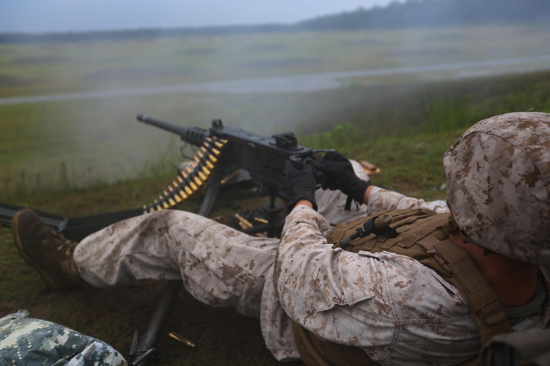 Lance Cpl. Aaron Philson fires a Browning M2 .50-caliber machine gun during a weapons familiarization range at Marine Corps Base Camp Lejeune, North Carolina, Aug. 27, 2015. More than 100 Marines from Marine Air Support Squadron 1 honed their weapons skills with the M240B machine gun, Browning M2 .50-caliber machine gun and the M1014 combat shotgun. Marines from various military job specialties received hands-on experience that allows them to improve crucial skills and become well-rounded war fighters. Philson is an aviation communications technician with MASS-1. (U.S. Marine Corps photo by Cpl. N.W. Huertas/ Released)