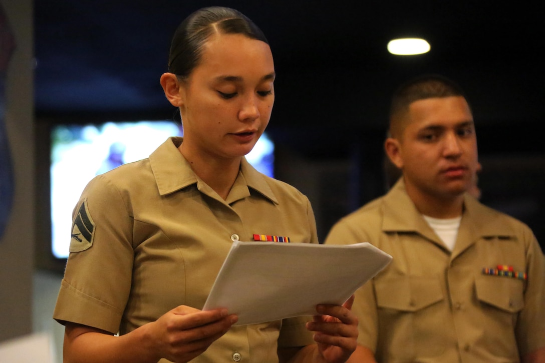 Cpl. Rosemarie E. Smith recites a letter from a witness during a 9/11 Memorial Service at Marine Corps Air Station Cherry Point, N.C., Sept. 11, 2015. Marines gather every September 11 to honor the fallen men and women of this tragedy in American history. Many remember what it was like to turn on the news and witness ash and debris cascade over New York City’s streets as bystanders scattered to safety. Marines endure vigorous and precise training to ensure they are proficient and always ready to protect their nation’s safety. Smith is a field radio operator with Marine Wing Communications Squadron 28. (U.S. Marine Corps photo by Cpl. N.W. Huertas/Released)
