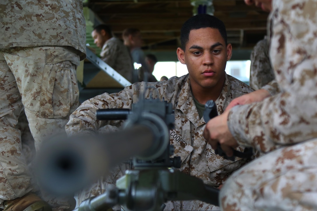 Cpl. Jevon Cooper receives a refresher class on a Browning M2 .50-caliber machine gun during a weapons familiarization range at Marine Corps Base Camp Lejeune, North Carolina, Aug. 27, 2015. More than 100 Marines from Marine Air Support Squadron 1 honed their weapons skills with the M240B machine gun, Browning M2 .50-caliber machine gun and the M1014 combat shotgun. Marines from various military job specialties received hands-on experience that allowed them to improve crucial skills and become well-rounded war fighters. Cooper is an air support operations operator with the squadron. (U.S. Marine Corps photo by Cpl. N.W. Huertas/ Released)
