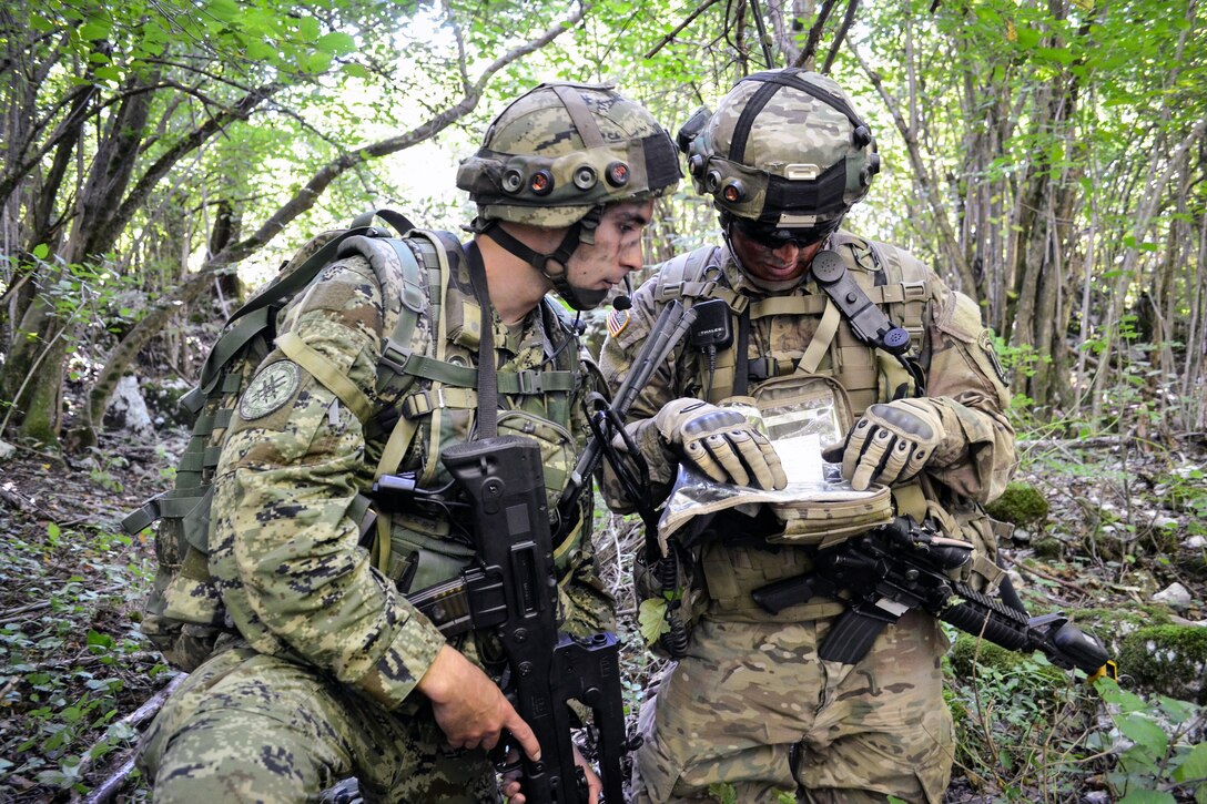 A Croatian soldier works with a U.S. Army soldier from the 173rd Airborne Brigade in a situational training lane during Immediate Response 15 in Slunj, Croatia, Sept. 12, 2015. Immediate Response 15 is a multinational, brigade-level, command post exercise utilizing computer-assisted simulations and field training exercises in Croatia and Slovenia. The exercises and simulations are designed to enhance regional stability, strengthen partner capacity, and improve interoperability. U.S. Army photo by Sgt. 1st Class Caleb Barrieau