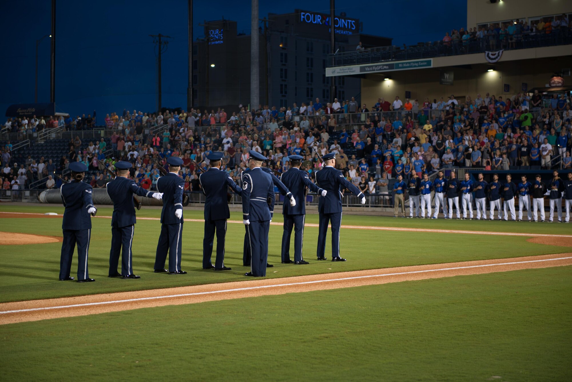 Members of the Keesler Air Force Base Honor Guard perform a 21-gun salute during a remembrance ceremony at the Biloxi Shuckers Minor League Baseball game Sept. 11, 2015, at MGM Park, Biloxi, Miss. The event honored those who lost their lives during the 9/11 attacks. It also included first pitches by a member of the local police department, fire department and each military service branch. The honor guard also performed taps and posted the colors. (U.S. Air Force photo by Marie Floyd)